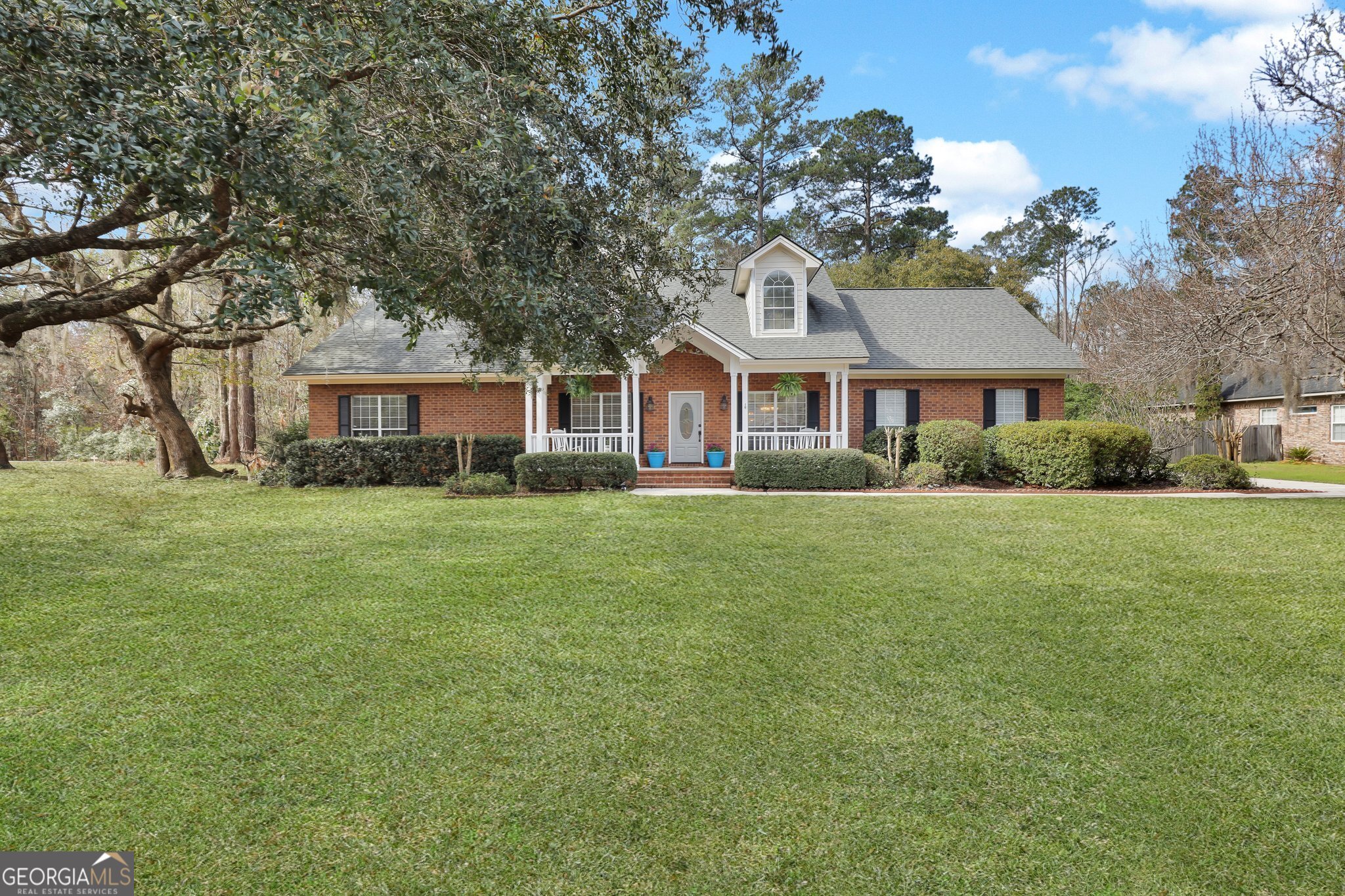 Welcome to this beautifully updated 4-bedroom, 3 full-bathroom brick home in the highly sought-after Marsh Harbour community. Situated on 0.96-acre, this home offers a brand-new roof, new HVAC system, new carpet, and fresh paint inside and out. The open floor plan features a kitchen with white cabinetry, granite countertops, stainless steel appliances, and a breakfast nook that flows into the main living area with hardwood floors and a wood-burning fireplace. The first-floor primary suite includes a jetted tub, walk-in shower, and large walk-in closet, while the upstairs fourth bedroom serves as a private suite for guests or family. Outdoor living is at its best with a cypress-screened porch, covered patio, and inviting front porch. Located in a waterfront community with access to a marina, dock, pool, walking trails, and a private boat launch, this home also offers a two-car garage and plenty of space to enjoy. Schedule your private showing today-this one won't last long!