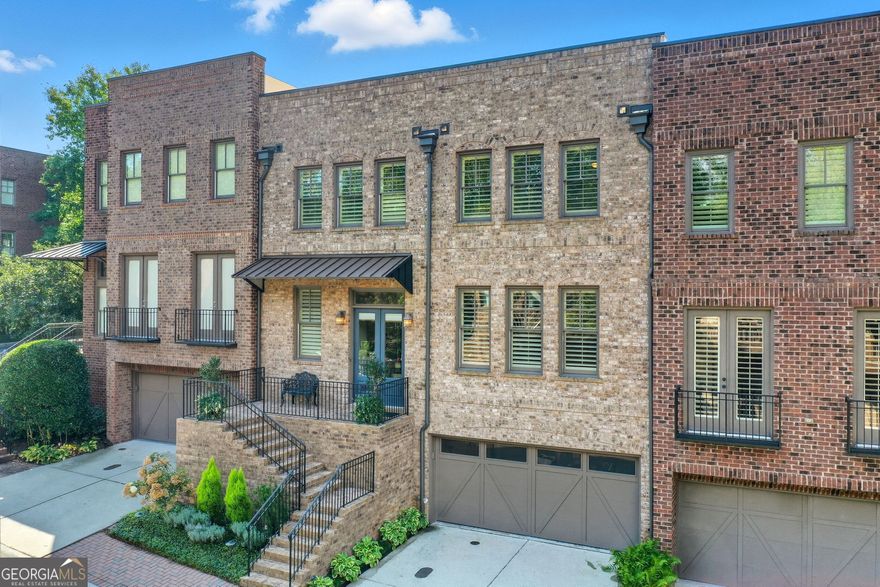 Experience the perfect blend of luxury and convenience in this beautifully maintained three-story townhouse, just steps from the vibrant Canton Street with its amazing restaurants, boutiques, and lively atmosphere.    Upon entering, you are greeted by a bright and welcoming foyer with elegant finishes that set the tone for the home's sophisticated style. A private elevator provides effortless access to every level. The open-concept main level features a stylish kitchen with Thermador appliances, a 9 ft. island, generous living room with fireplace and built-in bookshelves and double-french doors to a private office.  The basement is completely finished with a full bathroom, built-in shelves and a complete wet bar.  Double-french doors lead to a charming private courtyard with a peaceful water feature befitting of an al fresco meal or morning coffee.  Upstairs the primary features two sets of double-doors, jacuzzi tub and generous primary closet.  Two additional bedrooms, each with its own full en-suite bathroom, ensures comfort and privacy for all.  The two-car garage offers a unique separate temperature controlled storage area. Invite friends as there are two full parking spaces at the home with guest parking directly across the street.   Well cared for and thoughtfully appointed, this townhouse delivers the ease of low-maintenance living in one of the area's most sought-after locations. Enjoy the best of city living with a warm neighborhood feel-just moments from everything Canton Street has to offer.
