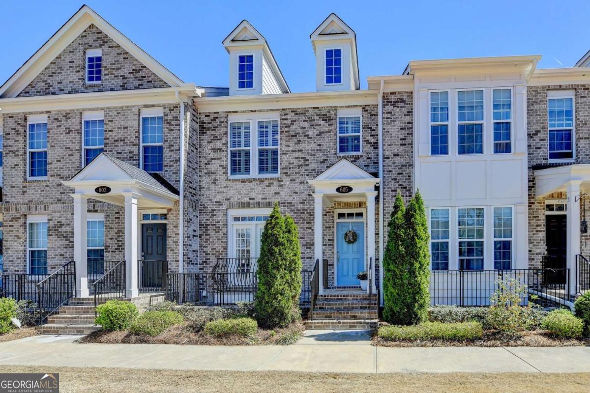 Luxury Townhome Living in the Heart of Alpharetta 605 Hanlon Way, Alpharetta, GA 30004 Located just steps from Avalon and minutes to Downtown Alpharetta and GA-400, this 3 bed / 3.5 bath, 3-level brick townhome with a 2-car garage offers the best of upscale, low-maintenance living in one of North AtlantaCOs most vibrant locations. From the moment you step inside, youCOre welcomed by an open-concept main level filled with natural light, custom plantation shutters, rich hardwood flooring, and elegant crown molding. The heart of the home is the gourmet kitchen, featuring an oversized island, quartz countertops, stainless steel appliances, a 5-burner gas cooktop, sleek vent hood, and a marble backsplash. You'll also find a wall-mounted oven and built-in microwave for a streamlined and modern cooking experience. The kitchen flows seamlessly into the dining area and spacious living room, where youCOll find custom built-ins and access to a private deckCoperfect for entertaining or relaxing outdoors. Enjoy additional main-level highlights like additional built-in cabinets, countertop and dry bar with beverage fridge, designer lighting, and a stylish dining area framed by French doors and transom windows, which bathe the space in natural light and add an elegant architectural touch. A powder room on this floor is ideal for guests. Upstairs, the ownerCOs suite is a serene retreat with tray ceilings, stylish lighted ceiling fan, additional recessed lighting, a spacious custom walk-in closet, and a spa-style en-suite bath complete with a frameless glass shower, dual vanities, and mounted flat-screen TV. An additional bedroom upstairs offers flexibility for guests or home offices and features an en-suite bath with double vanity and tiled tub/shower combo. A laundry room with built-in shelving is conveniently located on the same level. The terrace level features an additional guest bedroom that would also be perfect for a media room, home gym, or second home office, as well as a nook at the bottom of the stairs that would be a great reading/small office area. The 2-car garage includes additional built-in cabinetry and a small workbench area, offering extra storage and function for hobbies or tools. Community Amenities & Location: Walk to Avalon, shopping, dining, and entertainment Minutes to Downtown Alpharetta and the Alpha Loop Easy access to GA-400 and top-rated schools Community pool, sidewalks, and green space HOA includes exterior maintenance and landscaping This is the perfect opportunity to own a beautifully appointed townhome in one of AlpharettaCOs most desirable communities. Move-in ready, meticulously maintained, and close to everythingCothis one truly checks all the boxes.
