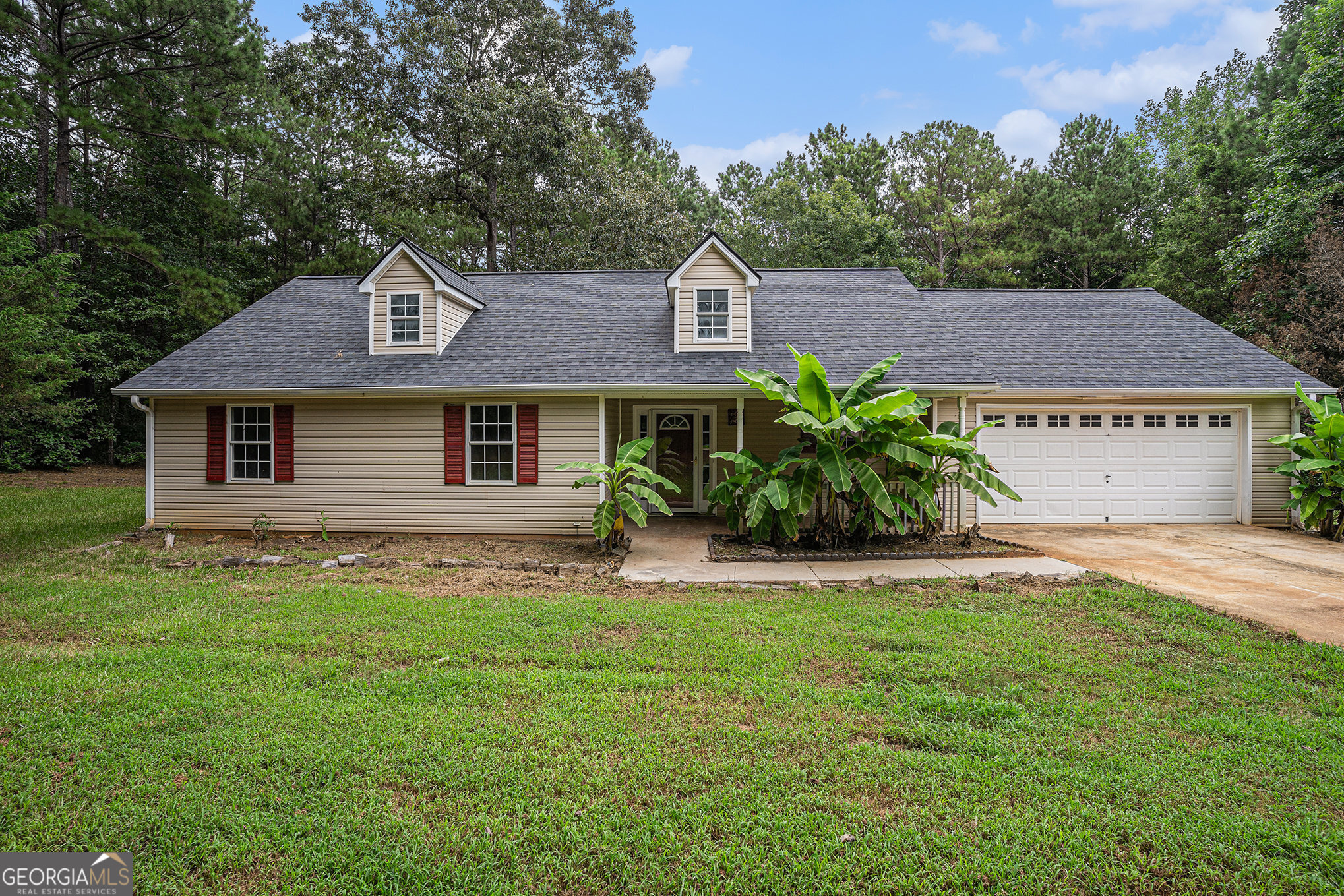Escape to your own private retreat with this charming 3-bedroom, 2-bath ranch tucked away on a peaceful cul-de-sac in Covington. Resting on over 3 acres of land, this property offers the space, privacy, and freedom you've been searching for-without the restrictions of an HOA. A welcoming covered front porch sets the tone for the home's inviting atmosphere. Inside, the spacious family room with a cozy fireplace provides the perfect gathering spot, while the kitchen with stained cabinets flows seamlessly into the dining area for easy entertaining. The primary suite is a true getaway, complete with a tray ceiling, walk-in closet, and a spa-like bath featuring double vanity, soaking tub, and separate shower. Two additional bedrooms and a full bath offer flexibility for family, guests, or a home office. Outdoors, the patio overlooks your expansive acreage, perfect for gardening, play, or simply enjoying the peace and quiet of your surroundings. Whether you dream of creating walking trails, setting up a firepit, or having room for recreational vehicles, the possibilities are endless. Short drive to downtown Covington, where you'll find charming shops, dining, and entertainment. Don't miss the chance to own this rare private retreat with room to grow!