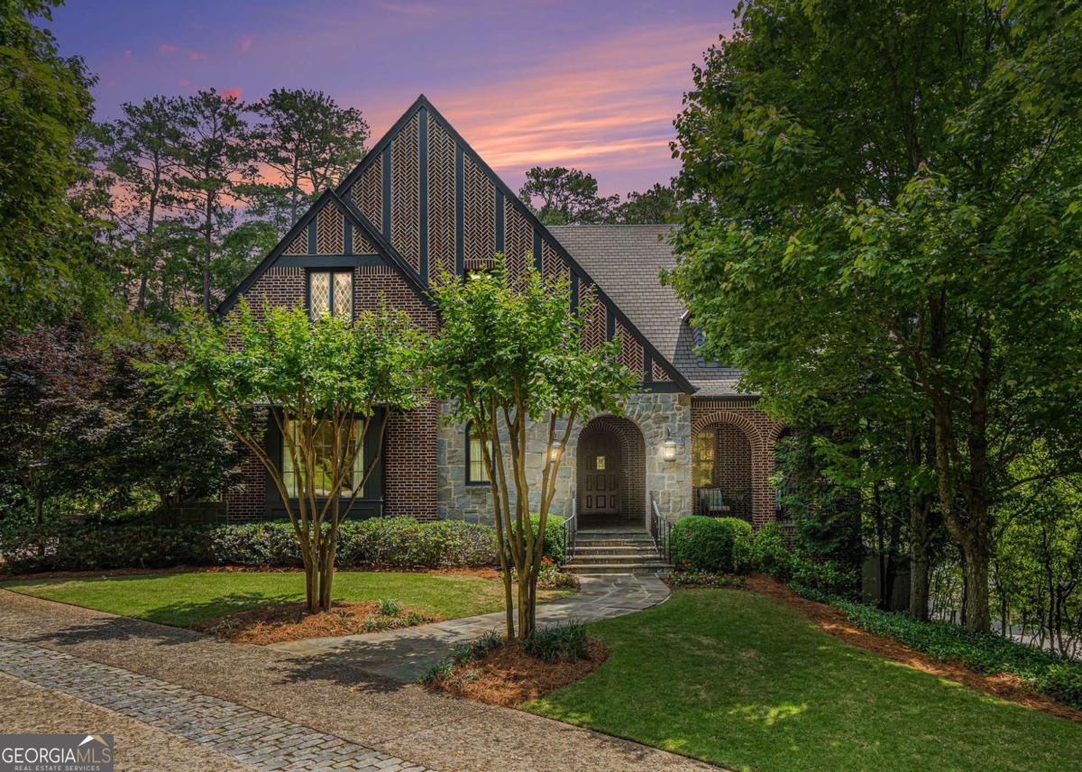 Morningside at its Very Best. This Outstanding Custom Built Home on Level Lot, with walk out Terrace level is Exceptional in every way. Built for these original owners, Enjoys an Outstanding Open Floor Plan, Great Attention to scale, function, form & flow, all while capturing abundance of natural light & maximum enjoyment. This 3 level with 3 car Garage, Brick & Stone Tudor Home, was Built by Owings & Avschlinsns, with Architectural work by Tim Adams. TS Adams Studio Architects. Every square inch of this house is in pristine, Move Right In condition. Ceilings are high, great attention has been spent on scale, moldings are rich and thick, hardwood floors are glistening, doors are solid, sturdy and timeless. Oversized, Custom Front door opens this beautiful home, and all its beautiful details. Generous foyer, opens to paneled library with Fireplace, Main Level Guest Suite, Large Dining Room with open Butler's Pantry, with great storage, connects to Heart of the Home, the Kitchen. Designed for maximum efficiency and enjoyment, large island with seating, built-in breakfast area, top-of-the-line appliances, walk-in food pantry, steps from separate office & screen porch with fireplace, overlooking lush level backyard and Oversized saltwater pool (16x40) and Green space. Super Handsome wide Open Central Staircase flooded with natural light, leads to the large landing and second floor, where three guest suites, one being the primary suite with Outstanding layout and intention to scale with his and her closets. Spa-like bath with large jetted soaking tub & steam shower. Guest suites on second level are very generous in proportion, with large walk-in closets, high ceilings,, and a very refreshing design. Terrace level designed for Recreation and Fun, with game room, TV/family room with built ins. Opens to wet bar with walk-in wine cellar, pool bath, fifth bedroom suite makes ideal Nannie or Guest Suite, large storage rooms, 2nd laundry room. Backyard enjoys great privacy with a beautiful Oversized Pool and Spa, multi sitting areas and Lush Gardens. This is one of those very special opportunities that rarely come to market.
