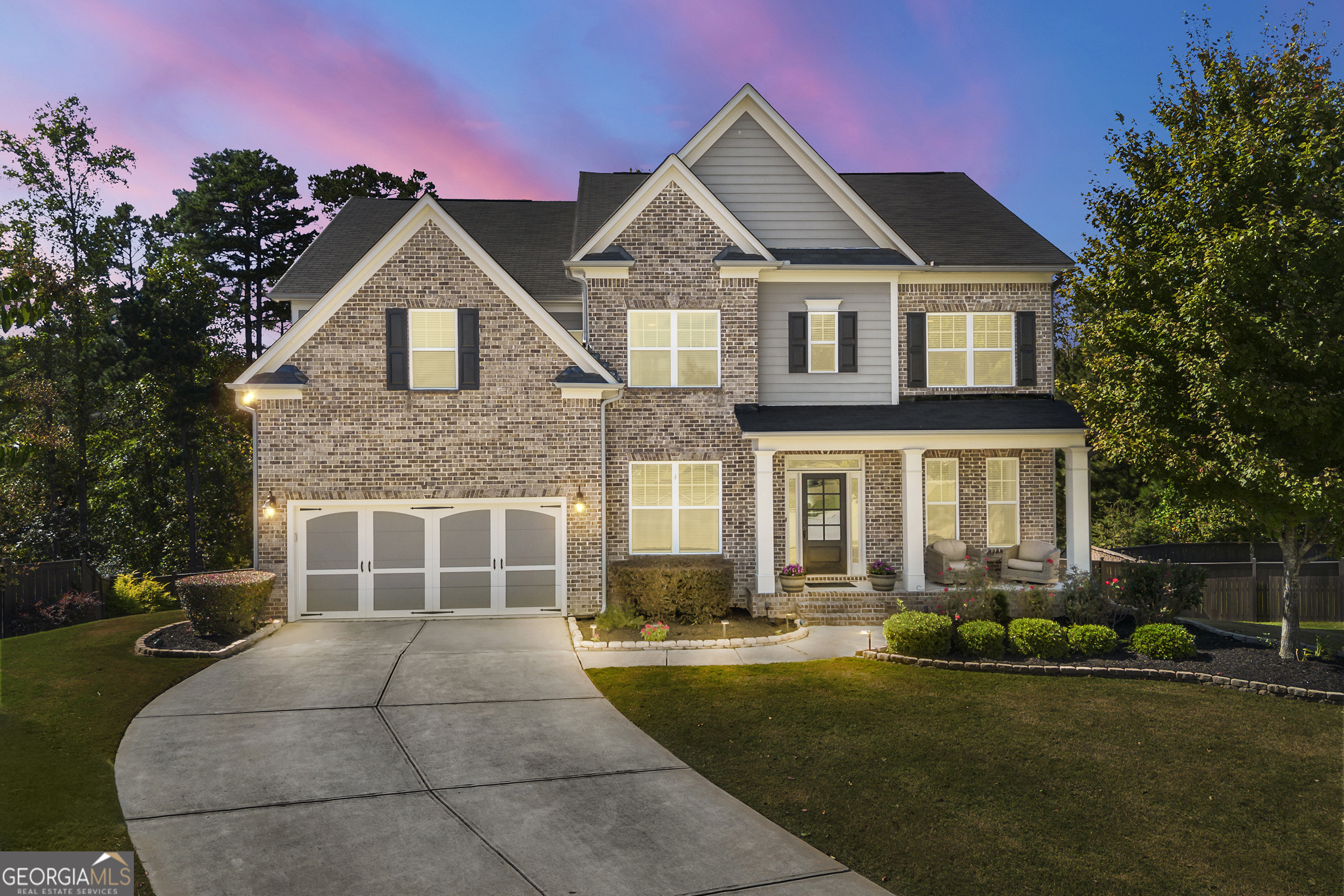 EXTRAORDINARY TRIPLE-LEVEL BRICK PALACE... Boasting nearly $250,000 in custom upgrades, this stunning pet-free immaculate luxury home is in one of the highest-rated school districts of renown Gwinnett County. Minutes to the Mall of GA, this like-new home is nestled in heart of very quite cul-de-sac. Level driveway leads to large, front covered porch... Enter home with formal office, formal dining room, and extra-large Grand room with "bowed" palladium windows- allowing a bright interior home. This entertaining open concept floor plan has a unique "Keeping Room" off the kitchen, providing a secondary entertainment area- can also be a sun room- yes, this home features a one-of-a-kind custom floorpan that sets it apart from the others! Full guest suite on main. Heavy trim package... Gourmet chef's kitchen with every luxury! Upper level features 4BRs/ 3 full BAs/ and an awesome 5th "step up" media room or 2nd office! Unique laundry room has private "pass thru" to elegant owner's bedroom suite. Almost no carpet- first & second floors hardwood, engineered wood- with basement level quality LVP. Terrace level is built out NICE!!! Features: Full guest suite with nicely appointed bath; game room or billiard room; bar or 2nd kitchen; theatre/ media room; and double-sized storage centers. Exit basement to super-sized screened in patio- overlooking BIG BIG sodded soccer-sized and level fenced yard- perfect for pool or play or gardening- and with amazing privacy... Some add'l notable features: (2) hot water heaters of 100 gal total; basement refrigerator remains- as well as the theatre seating. Being custom built in 2017 this home is only 9 yrs young and meticulously cared. Even comes EV-prewired at the garage! Community is very new, built out- and also has a wonderful family sports center. This gem has the WHOLE PKG folks... A sure-to-please winner on your list!
