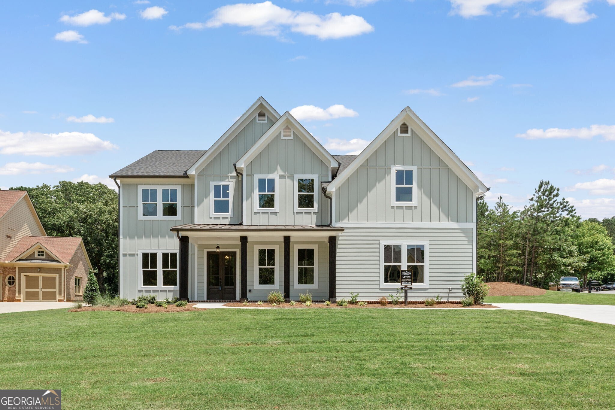 The Belville Plan built by Peachtree Residential Properties. Quick Move-In! Enjoy summer evenings on the rocking chair front porch. This brand new home has it all and offers a perfect blend of a beautiful new home and a place to enjoy the lake. All the homes in this 15 homesite community come with a deeded, covered, deep water slip located at the community dock. The lake is just a quick golf cart ride away for you to enjoy your boating adventures. The wide foyer is flanked by the Dining Room with wainscoting and a Flex Room that is perfect for an office or a place for a grand piano! The impressive 2 story Family Room has beautiful stained beams and plenty of windows. The fireplace has built-in cabinets on both sides and a wood fireplace surround. The open concept living is perfect for entertaining with a kitchen with cabinets to the ceiling, a large island, SS Kitchen Aid appliances, walk-in pantry and Breakfast Room. A bonus is the large Keeping Room with a vaulted ceiling. This home has a large Guest Room on the main floor wth a full bath, shower and a walk-in closet. Upstairs is a catwalk with hardwood floor, stained railing and metal balusters overlooking the Family Room. There is a reading nook at the upstairs hallway. The spa like Owner's bath has a shower, soaking tub and double vanities with quartz countertop as well as a walk-in closet and a smaller closet. Upstairs there are 2 secondary bedrooms with private baths. There are engineered hardwoods in the main living areas, carpet in the bedrooms and tile in the Laundry Room and Baths. This home has a 2-car side entry garage and a tandem garage. This is a beautiful level lot. This community is a perfect place to call home and is minutes away lake fun, dining and shopping!