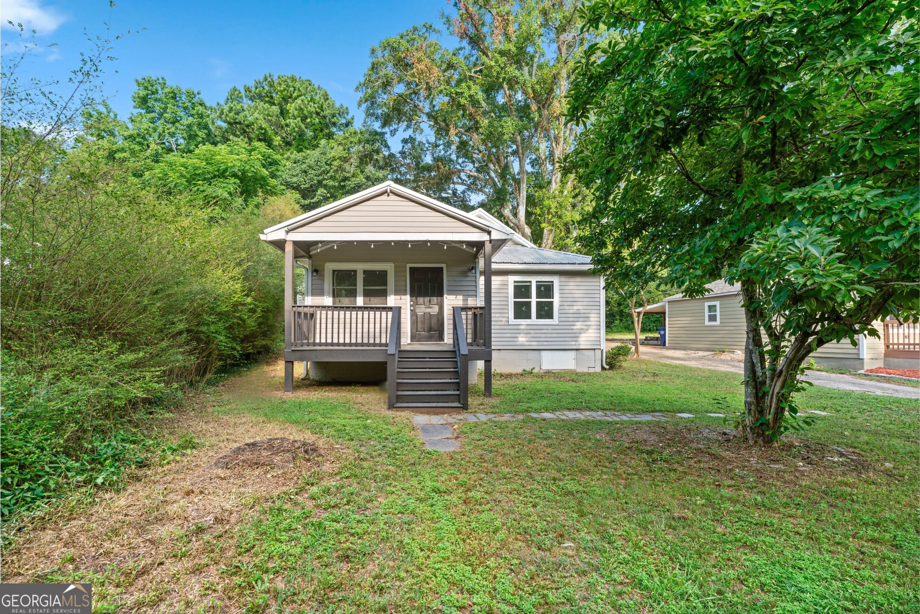 Cute, cozy, and close to everything! This updated bungalow sits just off downtown Winder, practically across the street from the newly revamped Fort Yargo State Park, and just a quick hop from the Exchange shopping district off Hwy 316. Even better? You're only about 30 minutes from Athens Go Dawgs! Step inside to find all new windows, sleek stainless steel appliances (just 3 years young), fresh white shaker cabinets, and gray laminate flooring that flows through the living room and kitchen. The gray carpeted bedrooms keep things comfy, while the WiFi-enabled thermostat adds a touch of smart-home convenience. This 2-bedroom, 2-bath home also offers a bonus flex space perfect for a third bedroom, home office, or playroom (your call!). Outside, the metal roof adds character, and though there's a shared driveway, you've got a 2-3 car parking pad tucked around back for plenty of space. Looking for easy living in a location that puts parks, shops, and downtown just minutes away? You've found it. Come check it out this one's got personality!