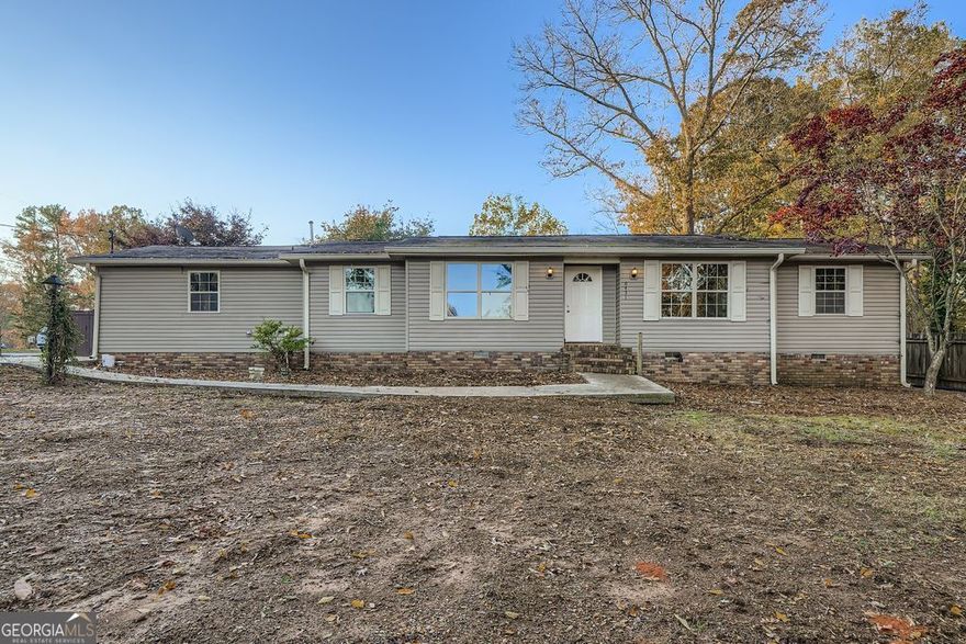 Welcome home to 6431 Courtney Dr.  This 3 bedroom/2 bath well maintained home is situated in a quiet established neighborhood off of Bright Star Rd.  The location is close to everything Douglasville has to offer.  When you step in the front door you are in an open concept living/dining/kitchen area.  Beautiful cabinetry highlights the spacious kitchen with a breakfast bar.  There is room for dining room furniture plus your big screen TV.  The 3 bedrooms are spacious with a beautifully renovated bathroom in the primary bedroom.  The third bedroom has a wall of shelves so it can be used as a bedroom or an office with space for all of your awards.  The secondary bathroom also has been renovated and expanded with beautiful tile work in the tub/shower combo.  There is bright and airy sunroom off of the kitchen with air conditioning for those hot summer days.  In the private back yard there is outbuilding that can be used as a workshop, a kitchen or space for a small business.  There is also a separate walk in cooler, it just needs the refrigeration system checked.  It is a spacious walk in storage room at the moment.  There is also a parking pad that will accommodate at least  a 42foot motor home.  There is power and a sewerage hookup for your RV or Food Truck.  The backyard is private with a wooden fence with a drive thru gate for the parking pad.  You could also grow some vegetables in the backyard! THE POSSIBILITIES AT THIS HOME ARE ENDLESS.  If entertaining is your thing, a food service business or small business this is the place for you.  Come see this cozy gem!!!!!   Interior pictures coming soon Nov 8th at the latest.