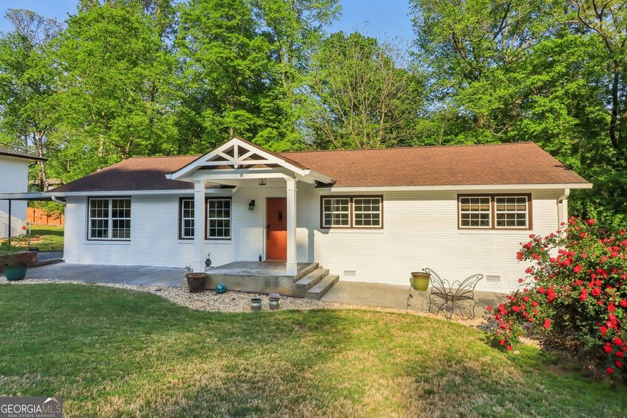 Beautifully renovated 3-bedroom, 2-bath home located in the heart of Marietta, just minutes from Truist Park, The Battery, Cumberland Mall, and quick access to I-75/I-285. This charming home features fresh interior and exterior paint, refinished hardwood floors, and thoughtful updates throughout. The kitchen opens to a cozy dining area and living space, ideal for everyday living and entertaining. One of the bedrooms includes a custom Murphy bed, perfect for guests or a home office. The spacious garage offers a built-in workspace and an electric car charger. Enjoy the outdoors with a screened-in back porch, fire pit area, and a beautifully landscaped backyard. Additional features include a covered carport, storage shed, and ample parking. This move-in ready home combines modern convenience with comfort in a prime Cobb County location.
