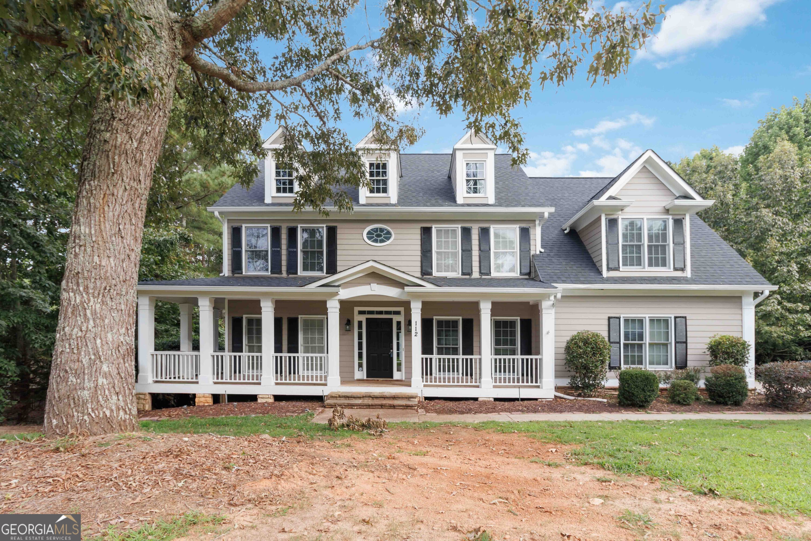 Welcome to Creekside Estates, a picturesque community in the heart of Cherokee County where charm, space, and convenience meet. This beautiful 5-bedroom, 3-bath home offers exceptional living with thoughtful design features throughout. Begin your mornings on the inviting rocking chair front porch, then step inside to discover a spacious layout ideal for both entertaining and everyday living. The main level includes a formal living room, a separate dining room, and a family room with a cozy gas fireplace. The kitchen is a chef's dream, complete with stained cabinetry, a double oven, breakfast bar, and ample counter space. Perfect for hosting, the main floor also includes a guest bedroom and full bath. Upstairs, the primary suite features a large en suite bath, dual vanities, and generously sized walk-in closets. Additional bedrooms are roomy and versatile, and built-in shelving adds charm and functionality. Need more space? The full unfinished basement offers endless potential for a home gym, media room, workshop, or additional living area. Enjoy nature and recreation just minutes away waterfall, Veterans Park, and other local favorites are just around the corner.