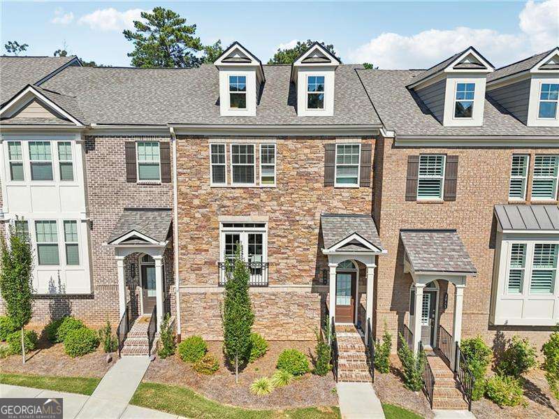 You found your new home!! Amazing location in Roswell. Just two miles from Canton Street, five miles from the Avalon in Alpharetta, minutes from golf courses, shopping, restaurants, Chattahoochee River, parks and the Ga-400. This beautiful home puts you close to everything and still maintains the serenity of suburban life. From the very first step into the home, you're greeted with upgraded hardwood floors, surrounded by a beautifully balanced contemporary design, a dining room filled with light that flows into the white quartz countertops and kitchen surrounded by 9ft ceilings. In the kitchen, you have an island that provides ample seating to entertain guests, cook, and eat. Custom cabinetry in the walk-in pantry offers more storage for all your kitchen needs. As you flow from the kitchen, you're welcomed by a living room that has not only a fireplace, space for an office but also direct access to a private back porch with nothing but trees and woods to meet your gaze. Here you have absolute peace to sit, drink your tea and be greeted by the sunset in the afternoons. Upstairs, the primary master bedroom offers an amazingly spacious walk-in closet, a dual vanity for both parties to have their space and an oversized shower enclosed by glass. The additional bedrooms also have their own deep closets and are equally gifted by natural light. The laundry room is conveniently on the upper level with its own custom cabinetry for additional storage. On the terrace level, you'll have direct access to an additional room with a full bathroom for a variety of uses for guests, entertainment, exercise room, and more. The terrace level has direct access to the garage with not only an electric car charging station, but also a custom mudroom to greet you back for seating, storage and shoe placement.