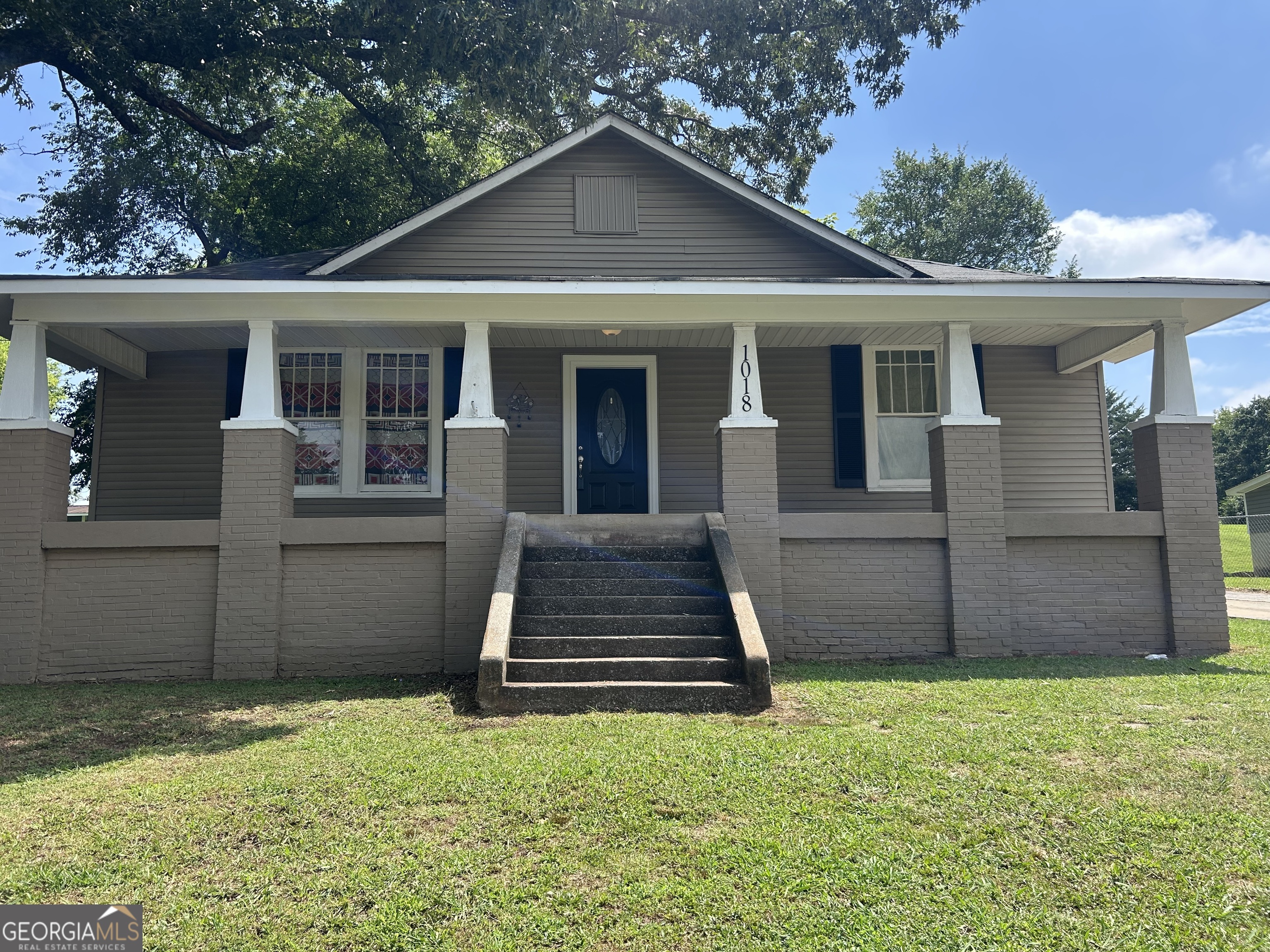 This is a spacious brick and vinyl sided bungalow style home that's close to town with dining close by. There are hardwood floors. Four Bedrooms two baths. All rooms and spacious. . A large front porch with a nice size back yard. Come see it today!