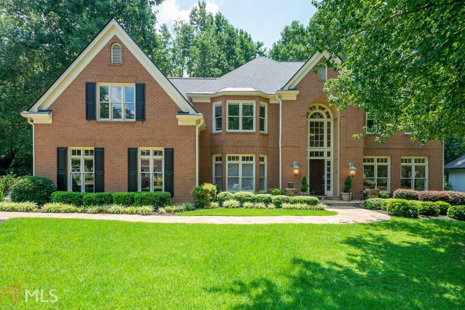 Sandy Springs renovated brick beauty w/ fabulous new kitchen in highly desirable Grogans Bluff on the most kid friendly/walking street! Stunning features in kit. are Alaska White granite, tiled walls, 5 burner gas stove with pot filler, double french door wall ovens, wine fridge, huge island w/ 2nd sink, breakfast rm w/ skylights open to dramatic fireside 2 story grt.rm has beamed ceiling. Banquet dining, library w/ wet bar, frpl., and in-law suite w/ balcony all on main floor covered in rich, dark stained hardwoods. New roof 06/20. Covered deck overlooking level, fenced backyard. Rear stairs lead to oversized master w/ 3 closets, lux bath and extra, private rm for sitting/office/nursery or gym. Loft overlooking great rm, 2 story foyer w/ archways, dramatic, lighted dome ceiling. Huge daylight basement with 2 more bedrooms and full bath also has fireside rec room or movie/game room and extra kids playroom or gym plus lots of storage space. SMART HOME features (for Alexa & Google) 4 NEST thermostats and sensors, wifi-enabled light switches and controls dishwasher/ovens. 3 fireplaces. Close to schools, hospitals, City Springs, the river and countless nature parks with walking trail. Easy access to GA 400. Highly socially active swim/tennis neighborhood.