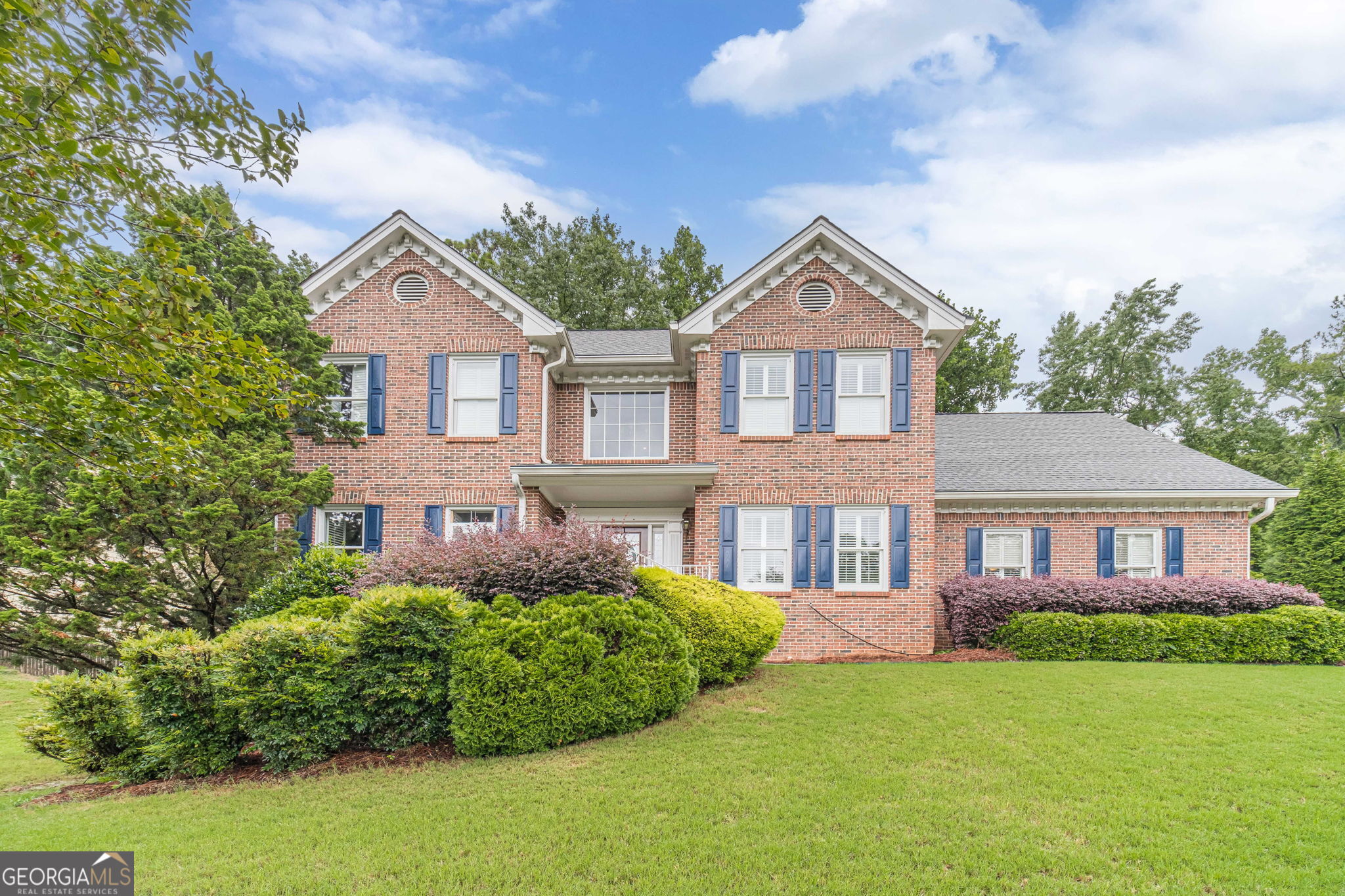 Located in the sought-after Flowers Crossing at the Mill community within the highly acclaimed Brookwood School Cluster, 1520 Providence Drive offers the perfect blend of location, comfort, and charm. This 4-bedroom, 21/2-bath home sits in a peaceful, well-established neighborhood where manicured lawns and mature landscaping create a warm and welcoming atmosphere. From the moment you arrive, you'll be greeted by the stately brick front exterior, inviting front porch, and timeless curb appeal. As you step inside, a two-story foyer sets the tone for the home's open and inviting feel. To the left, a versatile sitting room/home office offers a quiet space for work or relaxation, while to the right, a formal dining room creates the perfect setting for gatherings. The dining room flows seamlessly into the eat in kitchen, which features ample cabinetry, stainless steel appliances, solid-surface countertops, and a convenient breakfast bar all with views into the family room, making it easy to stay connected while cooking or entertaining. The primary suite is located on the main level, providing a private retreat complete with a walk-in closet and a bath featuring dual vanities, a soaking tub, and a separate shower. Upstairs, you'll find three additional bedrooms that share a full guest bath, offering plenty of space for family or guests. A full unfinished basement provides abundant storage space and the opportunity to customize and expand your living area to suit your needs. Step outside to enjoy a lush fenced in backyard ideal for relaxing, barbecuing, or outdoor dining. Living in Flowers Crossing at the Mill also means access to a wealth of amenities, including two swimming pools, a clubhouse, 10 tennis courts, playgrounds, a lake, and a vibrant swim and tennis community atmosphere. Conveniently located near schools, parks, shopping, and dining, this home truly embodies traditional charm with modern comfort. Schedule a showing today.