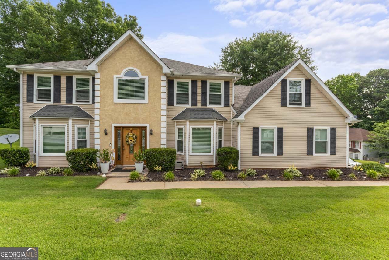 Welcome to this inviting two-story, four-bedroom, three-bathroom residence, meticulously maintained and nestled on a coveted corner lot in a peaceful neighborhood, offering an ideal haven for family living. As you approach, you'll be greeted by a beautifully manicured yard, showcasing the pride of ownership evident in every detail. The corner lot provides ample space and privacy, perfect for outdoor enjoyment and relaxation. Upon entering, you'll be greeted by a seamless blend of elegance and functionality. The main level features a convenient bedroom with a full bath, providing flexibility and convenience for guests or accommodating multigenerational living arrangements. The heart of the home lies in the well-appointed kitchen, boasting stainless steel appliances that elevate both style and functionality. From meal preparation to casual dining, this space is designed to accommodate the needs of a busy family. Adjacent to the kitchen, the family room beckons with its cozy fireplace, providing the perfect backdrop for intimate gatherings or quiet evenings at home. The brand-new double-pane windows throughout ensure energy efficiency and tranquility, allowing you to fully enjoy the serenity of your surroundings. Upstairs, you'll find the remaining bedrooms, each offering comfort and privacy for family members. The primary suite serves as a peaceful retreat, complete with its own en-suite bathroom and ample closet space, providing a sanctuary for relaxation. Outside, the yard offers endless possibilities for outdoor living. Whether you're gardening or simply soaking up the sunshine, this backyard oasis is sure to be a favorite spot for the whole family. Located in a quiet neighborhood, this home provides the perfect blend of tranquility and convenience, with easy access to schools, parks, and amenities. With its thoughtful design and meticulous upkeep, this residence offers a warm and welcoming atmosphere, making it the perfect place to call home for your family. Welcome to your new haven of comfort and serenity. Ask how you can receive up to $1500 credit by using one of our preferred lenders. Exclusions may apply.