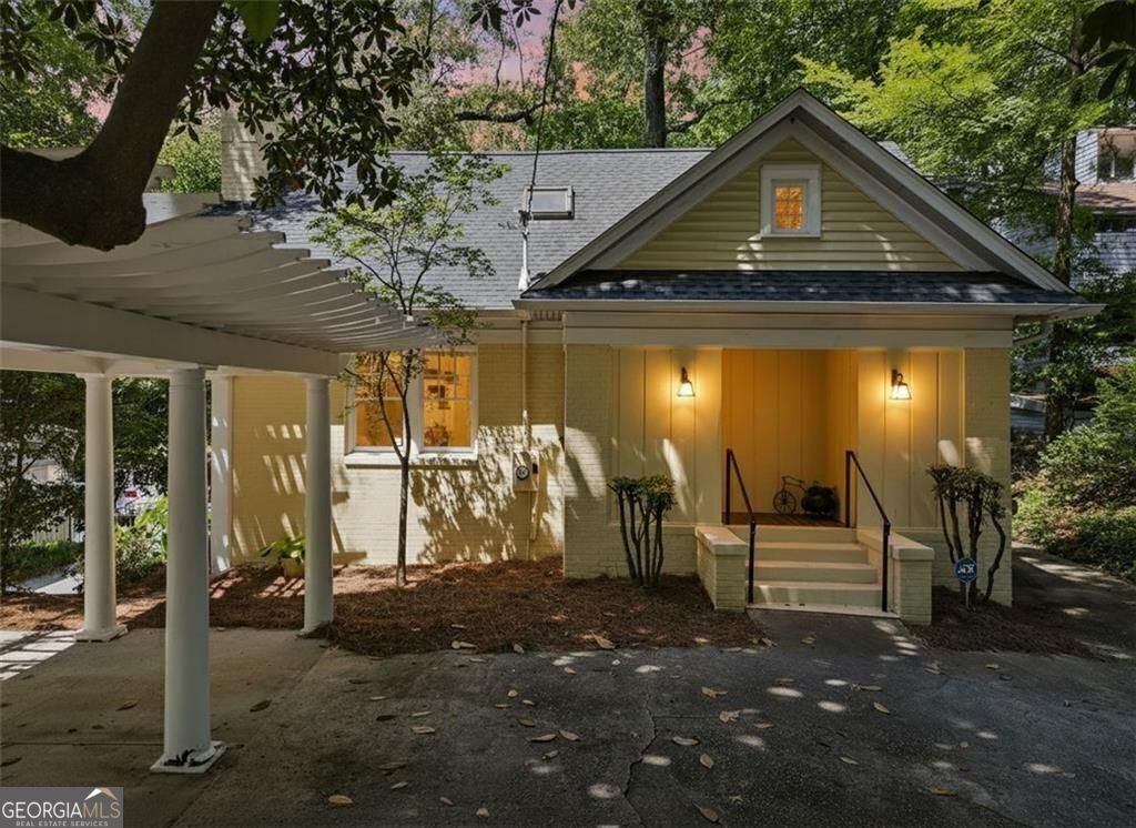 Tucked beneath mature trees in sought-after Peachtree Heights, this 1930s Craftsman pairs original character with smart updates and wooded privacy, right in the heart of Atlanta. Motivated seller-ready to make a deal. Step through the front door into a sun-filled living room anchored by a white brick fireplace and flanked by built-ins. Just off the living room, the sitting room offers a cozy space for conversation or quiet reading, while the formal dining room connects seamlessly to the kitchen. Solid-surface countertops, dark-stained cabinetry, and a gas range make the kitchen both functional and warm, with a nearby mudroom and pantry to keep things tidy and efficient. Two main-level bedrooms sit quietly toward the back of the home, each with its own closet and easy access to a full bath. A rear-facing sunroom with a wall of windows adds flexible space for work, play, or an afternoon recharge. Upstairs, every room is fitted with Velux rollout windows for natural light and fresh air. The spacious primary suite features a walk-in shower, soaking tub tucked under a charming sloped ceiling, and a massive walk-in closet that stretches over 25 feet deep, plenty of space to spread out and stay organized. Downstairs, an unfinished basement offers endless potential for storage or future expansion. Recent updates include a new furnace (2021), new AC (2023), and new hot water heater (2025). A wired alarm system and programmable exterior lighting add security and peace of mind. Out back, a terraced yard gives way to native landscaping, a storage building, and space to relax or entertain. The carport and extended driveway offer off-street parking for guests. Walk to the beloved Duck Pond, neighborhood pool, nearby parks, and the Saturday farmer's market. Minutes to Midtown, Buckhead, dining, shops, and trails, yet surrounded by trees and timeless charm.