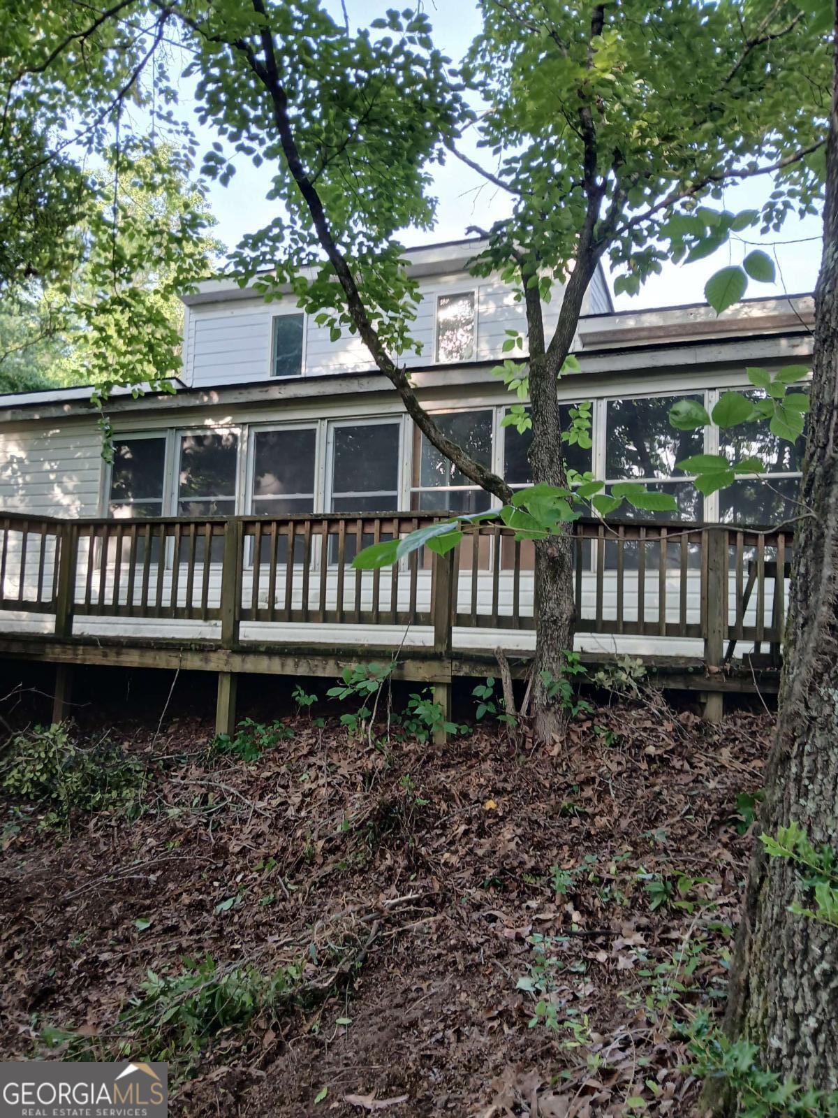 Country Ranch Cottage with Endless Potential! Discover this cozy 2 bedroom, 2 bath ranch cottage with versatile loft space, perfect for a first-time home buyer, retired couple or savvy investor for rental or flip. Situated on 1.25 acres along scenic Etowah River Road. This property offers privacy, space and freedom with no HOA restrictions. Build your dream home-the possibilities are endless. The lot could be cleared to create the ideal homesite. Bring your builder and imagination!