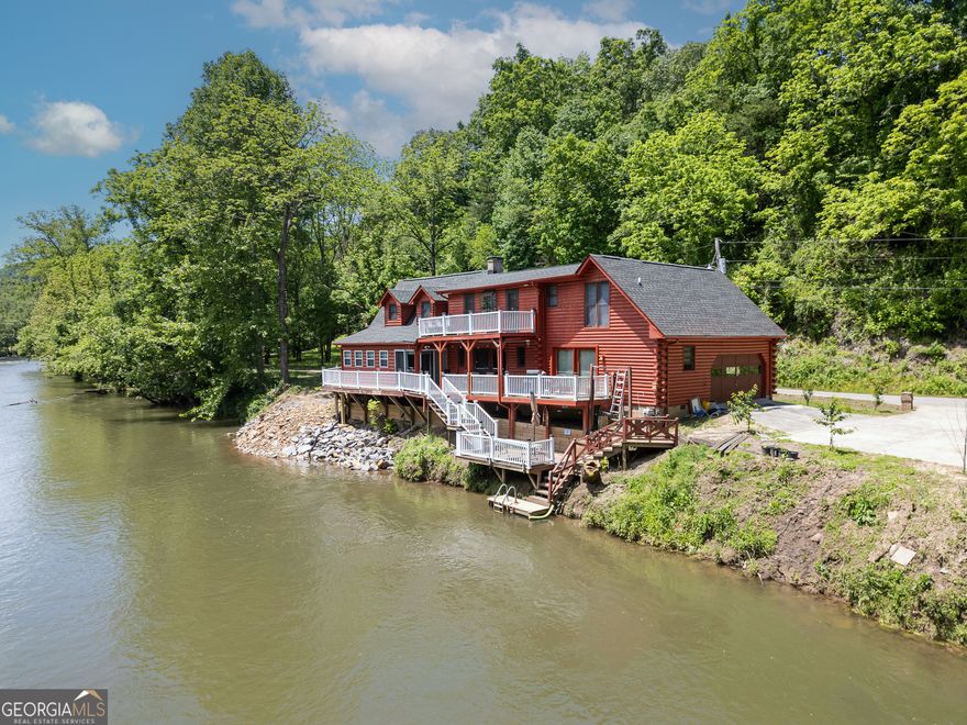 Fishing Paradise on the Hiwassee River - True Log Cabin with Stunning River Views. Welcome to your dream retreat! This cabin sits along the beautiful Hiwassee River, offering prime fishing right from your own deck. Enjoy the ultimate riverside lifestyle with a wrap-around deck and multi-level decks, perfect for entertaining, relaxing, or watching the river flow by. The home features primary suites on both levels, providing plenty of space and privacy, along with a third bedroom and a loft for guests or family. Home boast multiple levels of decks. One sit right on the water for fishing directly off you deck. You can't build this close to the water anymore! New roof and remodel completed last year. The two-car attached garage adds convenience, while the flat, usable yard offers ample space for outdoor activities, gardening, or even building a fire pit by the river. Located in the desirable Beaver Ridge subdivision, this property boasts paved road access and is just a short drive to downtown Murphy, the John C. Campbell Folk School, Tri-County Community College, and Erlanger Hospital. Whether you're an avid fisherman, outdoor enthusiast, or someone looking for a peaceful retreat close to amenities, this property has it all. Schedule a showing today and make this riverside paradise your new home!