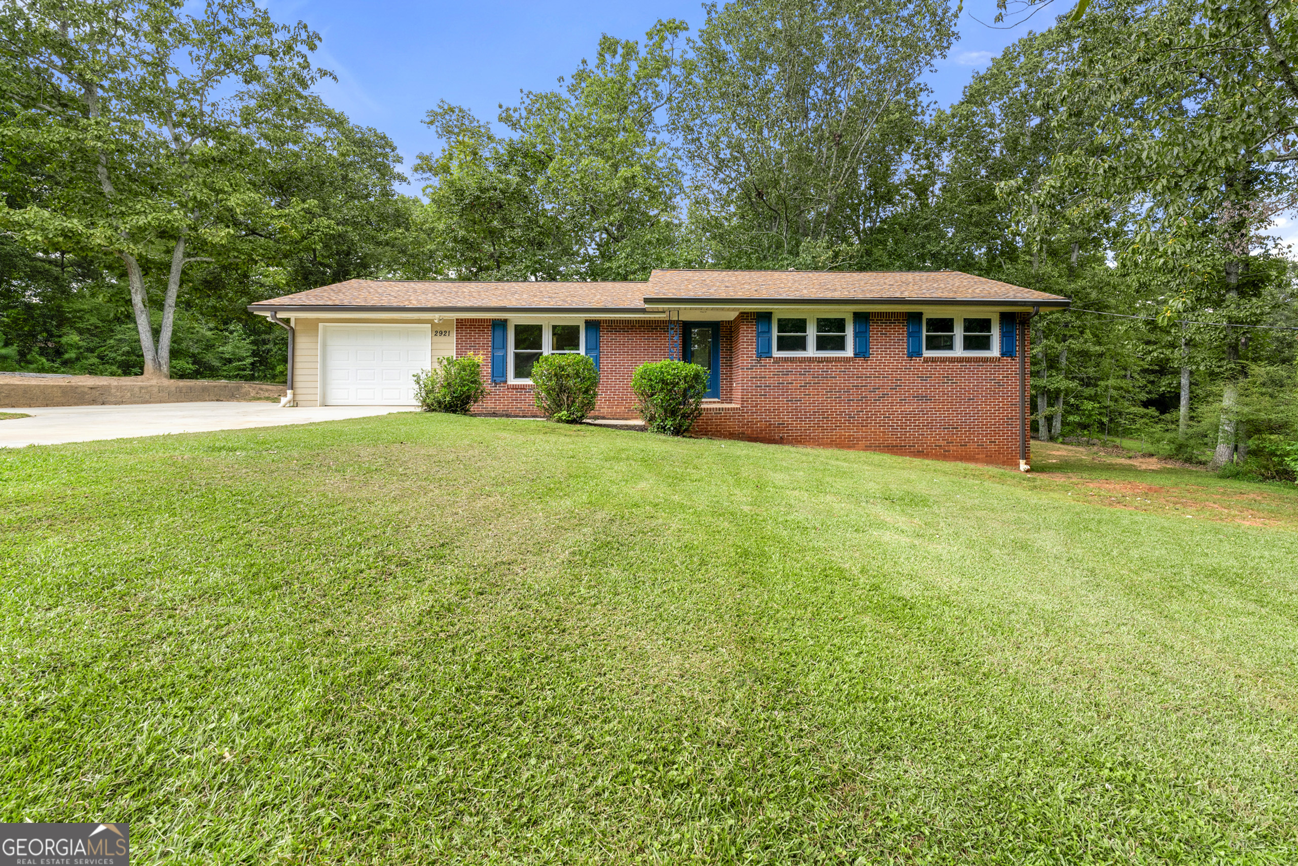 Welcome to 2921 Hill Circle, a stunning four-sided brick ranch that offers what today's buyers crave most: nearly an acre of prime land in the heart of Dacula, Georgia. This is a rare find that opens endless possibilities for small business operations, RV and boat storage, or simply the luxury of room to breathe that's becoming increasingly hard to find. This beautifully maintained home offers approximately 3,412 square feet of sophisticated living space, including four bedrooms, two full bathrooms, one half bath, and a bonus room-all designed with both comfort and functionality in mind. The main-level primary suite features a custom-organized walk-in closet, providing ease and elegance to everyday living while keeping everything conveniently on one floor. The heart of the home is the gourmet kitchen, which showcases stunning granite countertops, premium stainless steel appliances, and custom cabinetry with soft-close, pull-out drawers extending even into the pantry-a perfect blend of form and function. The open-concept design flows seamlessly into a warm, inviting family room with rich hardwood flooring throughout, while a thoughtfully designed laundry/mudroom adds exceptional utility with matching granite countertops and built-in storage solutions. The fully finished basement dramatically expands the home's versatility with an additional bedrooms, full bathroom, generous living area, and separate side entrance-ideal for multi-generational living, home office, guest accommodations, or potential rental income. The basement also features an Aquaguard Water Pump System for added peace of mind and protection. Positioned just 0.7 miles from the transformative Dacula City Core project-featuring a new municipal complex, open-air amphitheater, multifunctional greenspace, and central community hub set to complete in 2027-this location places you at the epicenter of Dacula's exciting future. In today's competitive market, you simply won't find another home offering nearly an acre of unrestricted land with no HOA restrictions under $400K. This is your opportunity to secure a property that delivers both immediate comfort and long-term value-where premium finishes meet practical luxury, and where space is never a compromise. Don't let this rare combination of location, land, and livability slip away.