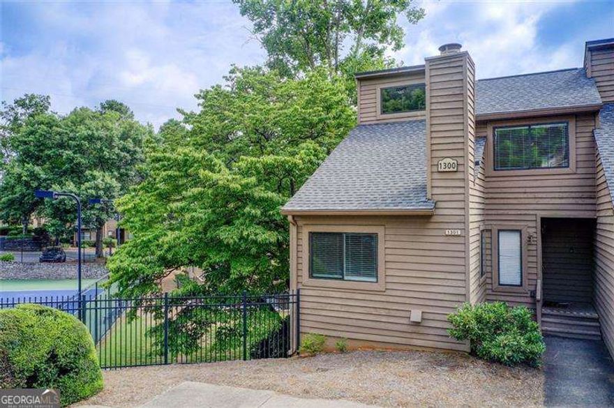 Fabulous location in East Cobb!  Walk to Kroger or bike to the Chattahoochee Boardwalk and Nature Park.  Sope Creek and Walton districts.   This end unit townhouse features soaring ceiling great room with corner fireplace.  Lots of windows.  Upstairs the primary bedroom is located on the back of the home with private bath and 2 closets.  The other bedroom features a ceiling fan and access to the hall bath.   Updated kitchen with stainless appliances and granite countertops with a wonderful walk in pantry.  Breakfast room with sliding door to the deck.  Downstairs is the real selling point.  Traditional bedroom with window and closet plus a very large room with builtins but no window that could be a 4th bedroom.  Full bath and large den complete the lower level.  All with access to the courtyard patio.    Amazing low HOA considering it includes water, trash and sewer plus the pool and tennis!