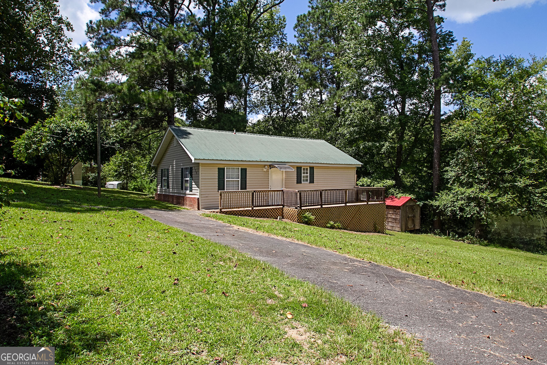 Escape to a private oasis less than 10 minutes from downtown Milledgeville and GCSU. This quaint 3 bedroom, 3 bathroom home sits on a private lot with lake views. The open concept kitchen opens to the living room with a fireplace. Each bedroom has it's own private bathroom, making this home perfect for roommates or extended family. Recently updated with flooring, paint, bathroom updates and more, this home is fully move-in ready. No rental restrictions for STR or long term rentals in community. Attic upstairs is insulated and mostly finished and could easily be completed to create loft space.