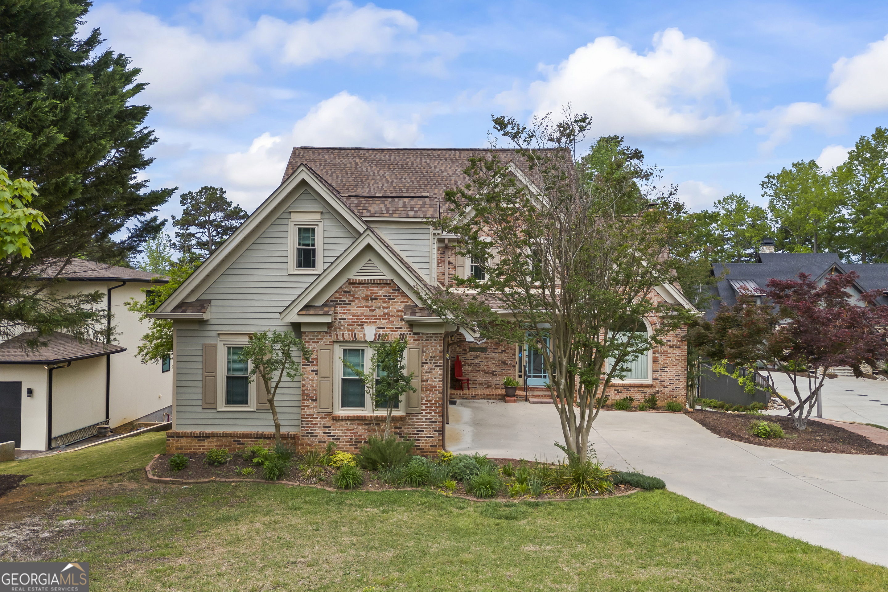 Welcome to your Lake Hartwell retreat in the highly sought-after Capri Point community of Lavonia, GA. This 4 bedroom, 3.5 bath lakefront home with a bonus room is perfectly designed for both full-time living and vacation getaways, offering breathtaking deep water views and a layout that blends comfort with functionality. Location is perfect for commuting with I85 just 15 minutes away, but also just a short drive to the beautiful Northeast GA mountains in under an hour. From the moment you enter, the lake becomes the backdrop to your everyday life. Expansive views can be enjoyed from the main living room, kitchen, finished basement, upstairs bedroom, and the master suite, creating a seamless connection to the water. The main-level master suite offers privacy and comfort with tranquil lake views, complete with an ensuite bath featuring double vanities, a large walk in shower, a soaking tub, and an oversized walk in closet. Upstairs, two spacious bedrooms are connected by a Jack and Jill bathroom, ideal for family or guests. A large bonus room over the garage provides versatile space that can serve as a game room, home office, or additional sleeping area. The finished basement extends your living space with a wet bar, a Pacific Energy wood burning stove installed by The Original Chimney Company, a spacious bedroom, a full bathroom, and an additional laundry room. Wiring is even in place for a sauna, should you wish to add one. Step outside the basement doors to relax in the hot tub, perfectly positioned to take in the lake views. Outdoors, you'll love the low-maintenance composite decking on the main level and freshly painted wood decking on the covered lower porch, which leads to a concrete pathway down to your private double slip dock with a boat lift, deep water, and sweeping open views. After a day on the water, unwind in the hot tub overlooking the backyard and lake. The property also features two 8x12 utility buildings surrounded by a custom built deck, perfect for storage, a workshop, or additional entertaining space. The fenced backyard provides a safe area for children or pets to play. With two laundry rooms, flexible living spaces, newer HVAC systems and hot water heater, and wiring in place for a whole house generator, this home is ready for year-round enjoyment and peace of mind. For today's lifestyle, the home is also wired for two different types of electric vehicle charging, with a Tesla charger already installed in the garage, a rare and valuable feature for lakefront living. With stunning views, spacious interiors, modern conveniences, and an unbeatable location on Lake Hartwell, this Capri Point home is truly move-in ready. Most furnishings and lake toys are negotiable, making it even easier to begin your new lake lifestyle. Are you ready to experience lakefront living at its finest? Schedule your private tour today! Virtual Tour on YouTube: https://youtu.be/KhnWeySBLkU