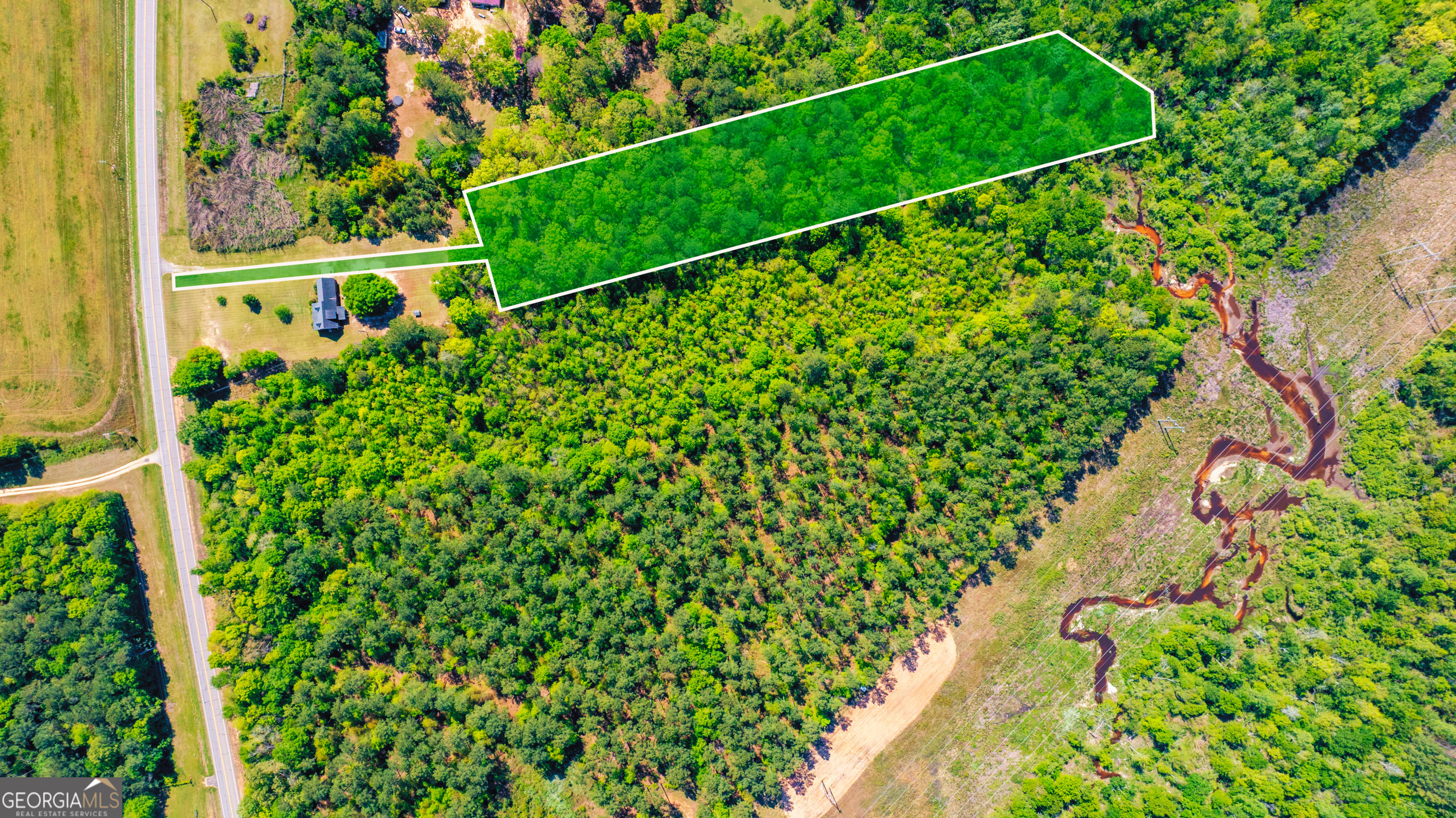 Discover the perfect blend of natural privacy and convenience with this 4.30-acre homesite in the desirable Oak Meadow community of Sandersville. Offering paved road frontage along Highway 24 East, this property features a picturesque open meadow, mature trees, and a tranquil creek at the rear - ideal for anyone seeking peaceful acreage with plenty of buildable space. With a brand-new survey on file and a completed soil percolation test, this lot is ready for your custom home. Zoned R-4 Residential for single-family homes only (no mobile homes or cabins), you'll benefit from light protective covenants and the freedom to build on your own timeline - no HOA restrictions. Utilities are close by, with power available once an address is assigned, and the property is easily accessible year-round by paved, county-maintained roads. Located minutes from downtown Sandersville, Riddleville, and Tennille, you'll enjoy quick access to shopping, dining, and everyday conveniences, as well as local recreation like Hamburg State Park and Shoal Pond. Whether you're ready to build now or want to invest in your own private retreat for the future, this property offers an unbeatable opportunity in the heart of Georgia's Kaolin region.