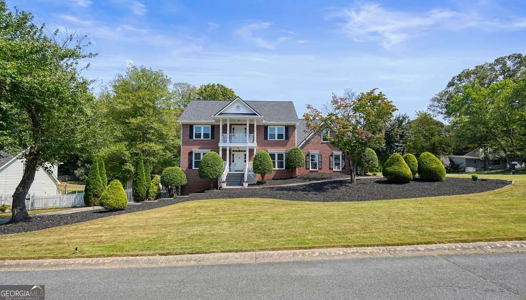 IMMACULATELY MAINTAINED brick Colonial in one of Woodstock's most sought-after neighborhoods, WILLOW CREEK! Lovingly cared for by its ORIGINAL owner, this stately 5-bedroom, 2 1/2 bath Colonial home combines timeless charm with meticulous upkeep. The builder of this home built this house after a home in Southern Living Magazine! Step inside to find spacious living areas filled with natural light, a tiled sunroom for morning sun coffee, a bonus space on the main level that could be used as an office, playroom, library, or anything your heart desires. There's also the convenience of two staircases. The home's oversized secondary bedrooms provide comfort and flexibility for family, guests, or home offices. An unfinished basement with a workbench (perfect for anyone who likes to work with tools or wood-working) offers excellent storage with endless potential for future expansion. It already has plumbing to add a bathroom, too, making it a great in-law suite with exterior and interior entry! Recent UPGRADES include NEW windows (2025), NEWER roof (2021), NEW carpet (2025), interior and exterior repainted (2025), NEWER HVAC, WHOLE house water filtration system, the list goes on and on. NEWLY refreshed 5-CAR GARAGE features fresh paint, 2 with epoxy flooring, and room to store multiple vehicles, plus space for a boat, four-wheelers, or a golf cart. A storage shed with electricity adds even more functionality. Outdoor living is equally impressive, with a covered back deck for year-round enjoyment and a private balcony-the perfect spot to relax and watch the sunset. Set in a fantastic neighborhood spanning two counties, your family would enjoy access to two community pools, a swim team, and welcoming amenities. The location is unbeatable-just five minutes from downtown Woodstock and close to highly rated schools, restaurants, and excellent shopping. If you're looking for a spacious home without the million-dollar price tag, this is the perfect place for your family to create memories for years to come with room for everyone to live, play and grow together. EVERYTHING has been done for you! Come see for yourself!