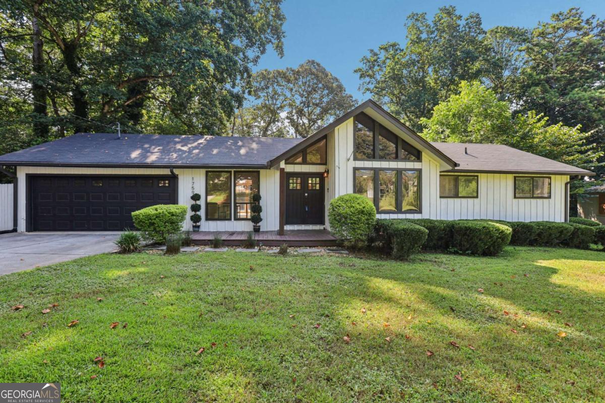 Beautifully updated home with timeless charm and modern touches! A sweeping front yard with mature landscaping sets the stage, while the large Southern-style front porch is the perfect spot to relax and enjoy a peaceful morning or evening. Step inside to find all hardwood and laminate wood flooring throughout-NO carpet! The welcoming foyer opens to a formal dining room ideal for hosting gatherings. The oversized living room is designed for both comfort and entertaining, with two generous seating areas, abundant natural light, access to the back deck, and a stunning stone fireplace as the focal point. The kitchen features ample cabinet and counter space, stylish tile backsplash, and room for casual meals in the bright breakfast room. Just off the kitchen, a large laundry room offers additional storage and convenience. The spacious primary suite is a true retreat, featuring a vaulted ceiling and a wall of windows that bring in gorgeous natural light. The beautifully updated en-suite bathroom includes striking glass vessel sinks, a large, fully tiled walk-in shower with frameless glass doors-offering both function and style. Two additional bedrooms are generously sized and share a full hall bathroom, ensuring room for everyone! Outside, the fully fenced backyard offers a private oasis with a large patio perfect for grilling and outdoor dining, a well-maintained lawn with plenty of green space for play or gardening, a storage shed, and an enclosed gazebo for relaxing or entertaining in any weather. Recent updates include a new furnace, fresh interior paint, updated plumbing, and new LVP flooring, ensuring peace of mind and modern comfort. All of this is conveniently located just minutes from Historic Marietta Square, where you'll find an array of restaurants, boutique shops, and entertainment options. Enjoy easy access to scenic hiking at Cheatham Hill Trailhead and Kennesaw Mountain, as well as nearby attractions like Jim Miller Park and Event Center, Truist Park for Braves games, concerts, and major highways for easy commuting, making this home an exceptional choice for both lifestyle and location. No HOA - No restrictions, come see this gem - schedule your private tour today!