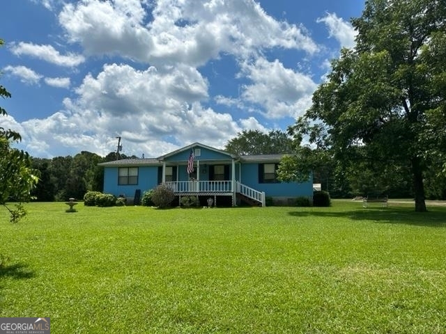 Located near Blue Springs Marina Lake Oconee, this 3 bedroom 2 bath mobile home sits on 3.03 acres of grass with a wooded backdrop. In addition to the home, there is a 4 stall carport with room for ample storage as well as 2 sheds and a concrete pad just waiting to be built on and utilized. New roof put on in January 2023. Home has been in the family since purchased and is being sold " as is." Easy access from Atlanta or Augusta for those looking for some peace and quiet or perhaps a mini farm. Morgan county's school system is one of the best in the state and has so much to offer.