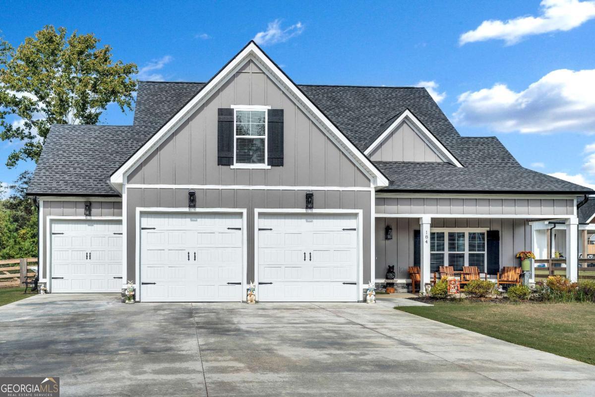 Nestled on a spacious, level lot in the heart of charming Ringgold, this beautifully designed two-year-old home welcomes you with warmth and modern elegance. Step inside to an airy open-concept main level where natural light dances across rich quartz countertops and gleaming stainless steel appliances in the kitchen, which flows seamlessly into a dining area and a cozy living room anchored by a striking specialty ceiling and a gas fireplace-perfect for gathering on cool evenings. The main-floor owner's suite is a serene retreat, featuring a luxurious ensuite with dual vanities, two oversized walk-in closets, a soothing soaking tub, and a large separate tiled shower. Upstairs, two inviting bedrooms and a full bath offer comfort and privacy, and finished bonus room upstairs offering tons of extra storage or guest space. Outside, enjoy the gentle breeze from covered front and back porches, ideal for morning coffee or weekend get-togethers. With a two-car garage and additional utility garage with OnCue sensors for garage doors - allowing for remote phone operation - and WPC 12 mil Vinyl Plan flooring throughout, this home blends convenience with timeless style in a truly peaceful setting. Schedule your showing today and make this one yours!!