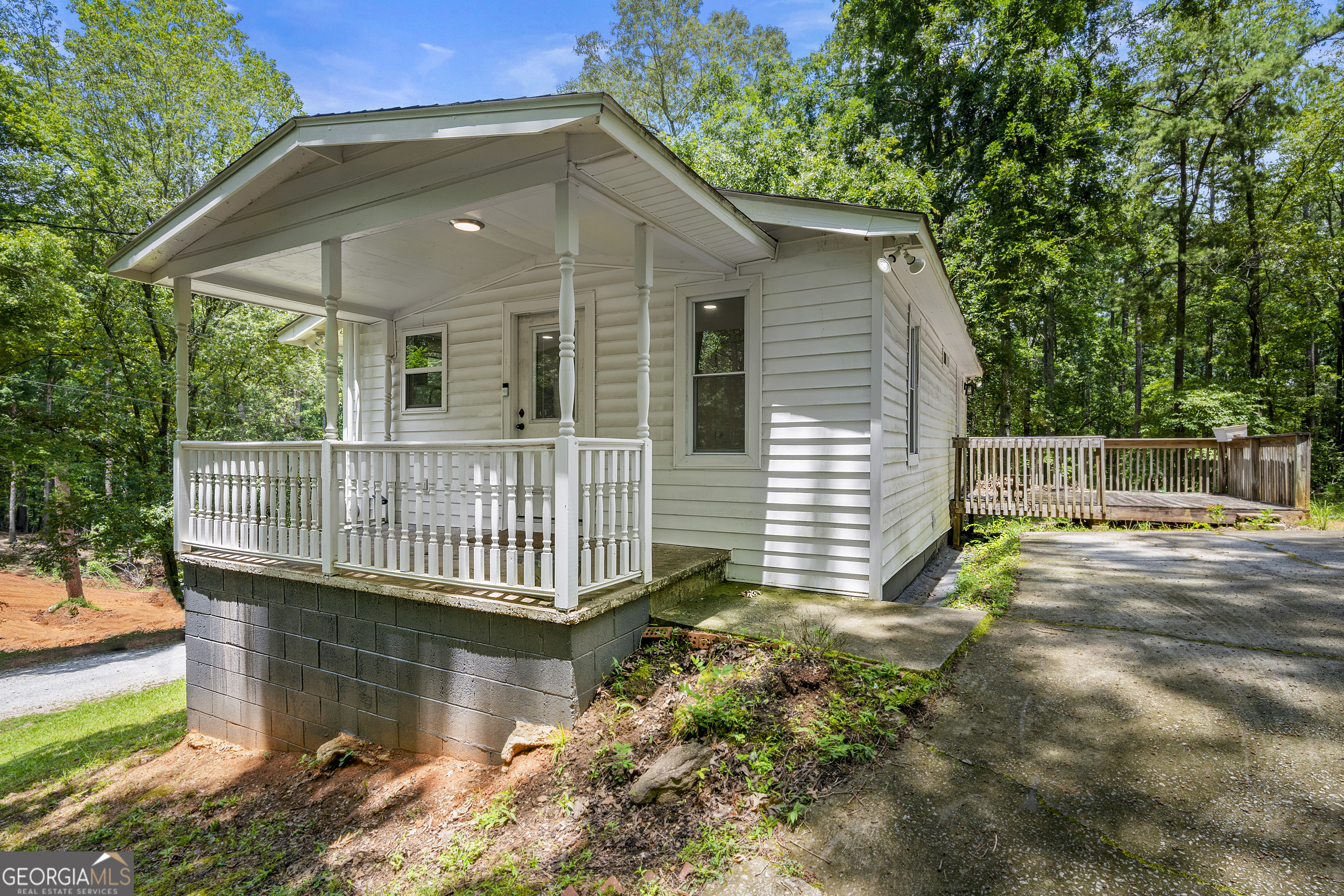 Discover the perfect blend of modern luxury and serene nature in this beautifully updated home situated on 0.78 acres, directly across from Sweet Water Creek State Park. This exquisite property features a brand new well pump and well house, ensuring reliable water supply. Enjoy the convenience of an existing easement for a secondary driveway, providing easy access from the other end of the property line. Step inside to find a stunningly modernized interior, complete with high-end finishes throughout. The main-level master bedroom offers direct access to a spacious back deck, a walk-in closet, and new doors and windows that flood the space with natural light. The lower level boasts elegant tiling, adding to the home's charm. Recent upgrades include new drywall, flooring, appliances, HVAC, and a roof, ensuring a move-in ready experience. The outdoor space is equally impressive, featuring a covered front porch, a workshop/outbuilding equipped with electricity, convenient hookups for RVs with both power and water readily available, and a concrete pad ideal for enjoying the full property-perfect for outdoor furniture or a gazebo. Additionally, a new septic tank has been fully replaced, with receipts available for peace of mind. This meticulously maintained property is a rare find, offering both privacy and proximity to nature's beauty. Don't miss your chance to make this exceptional home yours! *Photography will be uploaded 7/14/25*