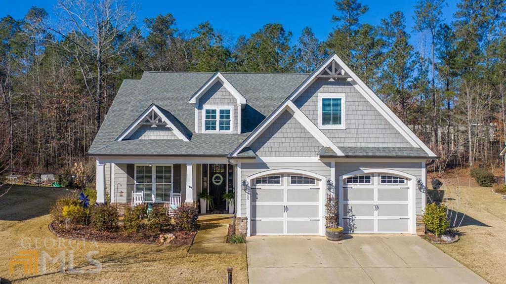 Move In Ready Jefferson Plan in Traditions at Carey Station. Attention to detail and numerous upgrades set this house apart from the rest. You will love the light fixtures, granite countertops throughout, marble backsplash in kitchen, ship lap, barn doors, extra storage space, spacious covered patio and fenced in yard out back. "They just don't build them like this anymore! "Close proximity to Lake Oconee Academy, St. Mary's Hospital and all the Lake Oconee Area has to offer.