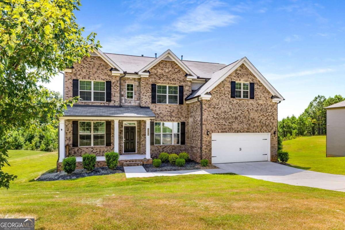 Welcome to your dream home - where space, comfort, and serene views come together beautifully! This impressive 4-bedroom, 3-bathroom residence offers an open-concept design filled with natural light and thoughtfully designed living areas. You'll love the convenience of a full bedroom and bathroom on the main level - perfect for guests or multigenerational living. The heart of the home is the breathtaking two-story living room with soaring ceilings, a cozy fireplace, and a dramatic wall of windows that provide a peaceful, private view of the backyard and surrounding nature - no rear neighbors, just tranquil beauty. Overlooked by a striking catwalk, this space seamlessly connects to the chef's kitchen, which features granite countertops, a spacious island, stainless steel appliances, double ovens, a built-in microwave, and a dishwasher - ideal for everyday living and entertaining. Upstairs, unwind in the expansive primary suite, complete with a luxurious en-suite bath and an oversized walk-in closet. Two additional bedrooms offer plenty of space for family, guests, or even a home office setup. Step outside and enjoy a generous backyard with a deck that's perfect for summer barbecues or peaceful morning coffee. Plus, the large unfinished basement offers endless possibilities - create a home gym, media room, or extra living space tailored to your needs.This home truly has it all - thoughtful layout, stylish finishes, and space to grow. Don't miss your opportunity to make it yours!