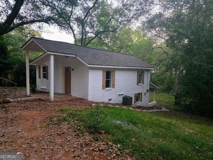 Move in Ready remodeled 2 bedroom 1 bath home - master on main- split bedroom plan- downstairs bedroom has outside entry and covered porch overlooking backyard- New paint , new flooring, New shutters, located on a dead end city street within waliing distance to churches, library, hospital and downtown area- very private - brick and vinly siding- possible owner financing available for qualified buyer