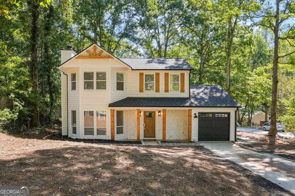 Discover Timeless Elegance on a Spacious Corner Lot! Welcome to 843 Greenhedge Way, a fully renovated 3BD/2.5BA masterpiece in vibrant Stone Mountain-where modern luxury meets farmhouse charm. Spanning over 1,800 sq ft, this spectacular home feels like new construction, with every detail upgraded in 2025 for effortless, high-end living. Step inside to stunning new LVP waterproof flooring flowing across the main level, leading to a chef's dream kitchen boasting custom cabinets, leathered granite countertops, a farmhouse sink, and a massive pantry with chic barn doors. New lights, faucets, vanities, and doors throughout add polished, move-in-ready sophistication. Upstairs, the oversized primary suite is a true retreat, featuring a walk-in closet and spa-like porcelain tile shower. Two additional generous bedrooms share a well-appointed hall bath. Outside, the expansive corner lot shines with 2025 upgrades: new roof, gutters, water heater, and a sleek garage with automatic opener (HVAC ~5 years young for peace of mind). Nestled in a sought-after neighborhood with easy access to parks, shopping, and Stone Mountain's natural beauty, this home stands out. It delivers premium finishes at an unmatched value. Schedule your showing today! Key Updates (All 2025 Unless Noted): New roof, gutters, water heater, garage door with opener, LVP flooring, leathered granite counters, custom cabinets, farmhouse sink, pantry with barn doors, interior doors, lighting, faucets, vanities. High-end farmhouse decor throughout.