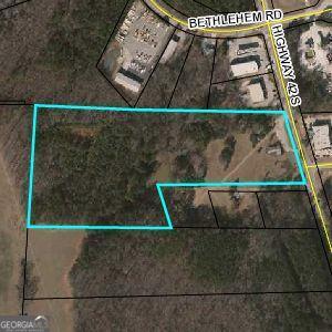 PRIME RE! We are pleased to inform you that this significant parcel is being sold cooperatively and entirely with 3 other parcels (4 parcels total; parcel #'s: 7321813 ). Combined, they offer a remarkable 23.25+ acres of land, presenting an excellent opportunity for long-term prosperity. With a prime location boasting 646 feet of frontage on Highway 42, these lots are strategically situated across from Park 42 and in close proximity to the newly constructed Home Depot & Locust Grove Distribution Corporate Office Centers, alongside other thriving businesses. Additionally, the bustling Tanger Outlet, Walmart, Ingles shopping centers, and I-75 are all conveniently located within a mile. This versatile property is ideally suited for a range of ventures such as retail, pharmacy, hotel, office complex, restaurant, distribution center, or semi-trailer parking. Rest assured, all necessary utilities are readily available. Thank you for considering this exceptional opportunity.