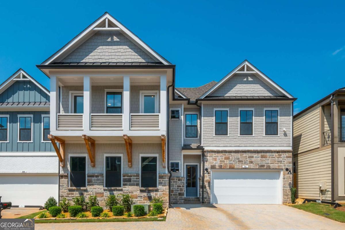 Incredible value for BRAND NEW CONSTRUCTION just minutes from Downtown Woodstock in the charming gated community of The Village at Towne Lake! Take advantage of a $25,000 seller incentive to help make this dream home your reality. Just over a mile from vibrant Downtown Woodstock and minutes from I-575, this Seaside A floorplan by Davidson Homes boasts over 3,900 sq. ft. of thoughtfully designed living space and designer finishes. The open-concept main floor with soaring 11-foot ceilings lives large and flows seamlessly. The stunning chef's kitchen is complete with a large island, Quartz countertops, dual pantries, designer backsplash, and stainless steel appliances. Open the floor to ceiling sliding glass doors to the private courtyard with a covered porch and pavers for easy entertaining and everyday relaxation. The highly desirable primary suite on the main level features a spacious, spa-inspired bathroom with dual vanities, soaking tub, dual shower and a large walk-in closet. There is an additional bedroom and full bathroom on the main floor perfect for guests or as an office. Upstairs, enjoy 10-foot ceilings and plenty of space for family or guests with spacious bedrooms, en-suite bathrooms, and a bonus living room. In addition, don't miss the hidden "speakeasy" media room complete with a wet bar and half bathroom. A three-car garage provides generous parking and ample storage. This home is outfitted with over $60,000 of structural options and upgrades throughout! The Village at Towne Lake offers an exceptional lifestyle with charming architectural details and resort-style amenities including a luxury clubhouse, fitness center, pool, tennis courts, and pickleball, all within minutes to nearby Woofstock Park, Main Street in Downtown Woodstock, and many other shopping, dining, and outdoor options. Don't miss the opportunity to make this unique new construction home your own. Builder home warranty provided to buyer at closing. Consider using $25,000 for a rate buydown - this could help make your monthly payments noticeably lower for the first two years, giving you some breathing room upfront.
