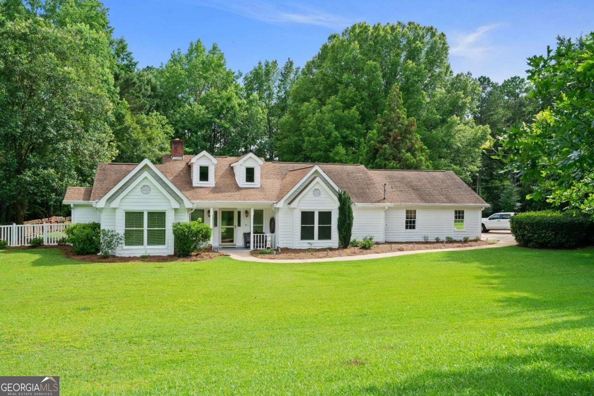 Welcome to 145 Deep Step Rd - country living at its finest! This beautifully maintained 3-bedroom, 2-bath home offers over 2,100 square feet of comfortable living space on a peaceful, spacious 2.1 acre lot. A long private driveway leads to a 2-car garage, while the charming front porch welcomes you in. Step inside to find generous-sized rooms, a cozy brick fireplace, and soaring ceilings in the family room that create an open, airy feel. Enjoy morning coffee in the bright sunroom or entertain guests on the level back patio overlooking the expansive back yard. Built in 1990, this home has been lovingly cared for and is move-in ready. If you're looking for space, comfort, and quiet country charm, this is the one!