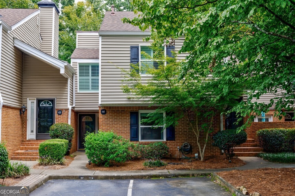Welcome to effortless living in the heart of the Perimeter! This beautifully updated 2-bedroom, 2-bath one-level condo offers the perfect blend of style, comfort, and convenience. Step inside to find a light-filled open floor plan with a modern kitchen featuring crisp white cabinetry, sleek countertops, stainless steel appliances, and abundant storage-flowing seamlessly into the spacious great room with fireplace and private courtyard,or deck which is ideal for relaxing or entertaining. Both bathrooms are fully renovated with designer tile, custom vanities, and upscale finishes, while the roommate-style layout provides privacy and flexibility. Tucked away against a peaceful wooded backdrop, you'll enjoy serene views just steps from world-class dining, shopping, and easy access to GA 400 and I-285. Resort-style amenities complete the package: a sparkling pool, lighted tennis courts, clubhouse, and 24/7 fitness center. Whether you're seeking a move-in-ready home, a perfect investment, or lock-and-leave convenience, this condo delivers it all-making it a must-see before it's gone!