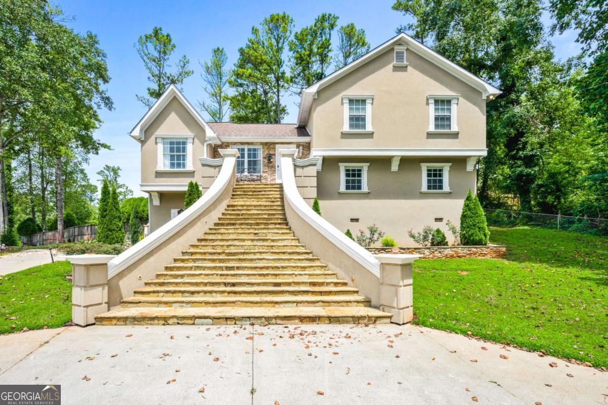 Experience effortless elegance and comfort in this thoughtfully updated 4-bedroom, 3.5-bath traditional home. A grand two-story foyer welcomes you into the spacious great room, complete with a statement stone fireplace-perfect for lively gatherings or quiet nights in. The formal dining room showcases classic charm, while the upstairs bedrooms provide privacy and warmth. Slide open the back patio for weekend BBQs or morning coffee on the spacious level lot. The partially accessible basement adds exciting potential for storage, a home gym, or hobby space. Situated in the coveted Russell Plantation Estates, the home offers easy access to top schools, shopping, and highways.