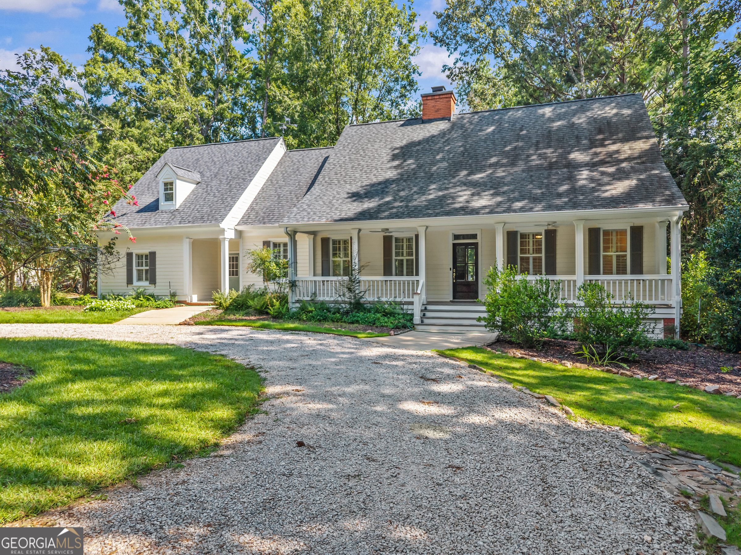 SWEEPING LAKE VIEWS, STEPS FROM THE 18TH HOLE AT GREAT WATERS, AND WITHIN WALKING DISTANCE TO PREMIER REYNOLDS GREAT WATERS AMENITIES. Set on nearly an acre, this home offers a prime location along the renowned Jack Nicklaus designed Great Waters course and is just a short walk to the world class amenities of Reynolds Lake Oconee. Step inside to soaring ceilings and an open layout designed to capture natural light and water views, with hardwood floors throughout the main living areas. Off the entry, the formal dining room flows into the great room, anchored by a floor to ceiling fireplace and expansive windows. The updated kitchen features an oversized island, an additional eating area, and ample storage, with the laundry room conveniently nearby. Step onto the large back deck to relax, dine, or entertain with the lake as your backdrop. The main level primary suite offers privacy with a spa like bath and walk in shower. Upstairs, a loft landing makes a cozy reading nook or sitting area. Two bedrooms share a full bath, while a third has its own en suite, perfect for kids or visiting guests. Close to the prestigious golf course, clubhouse, pool, tennis courts, and restaurant, and just a short boat ride to the Ritz Carlton, this home offers easy access to all that Reynolds Lake Oconee has to offer.