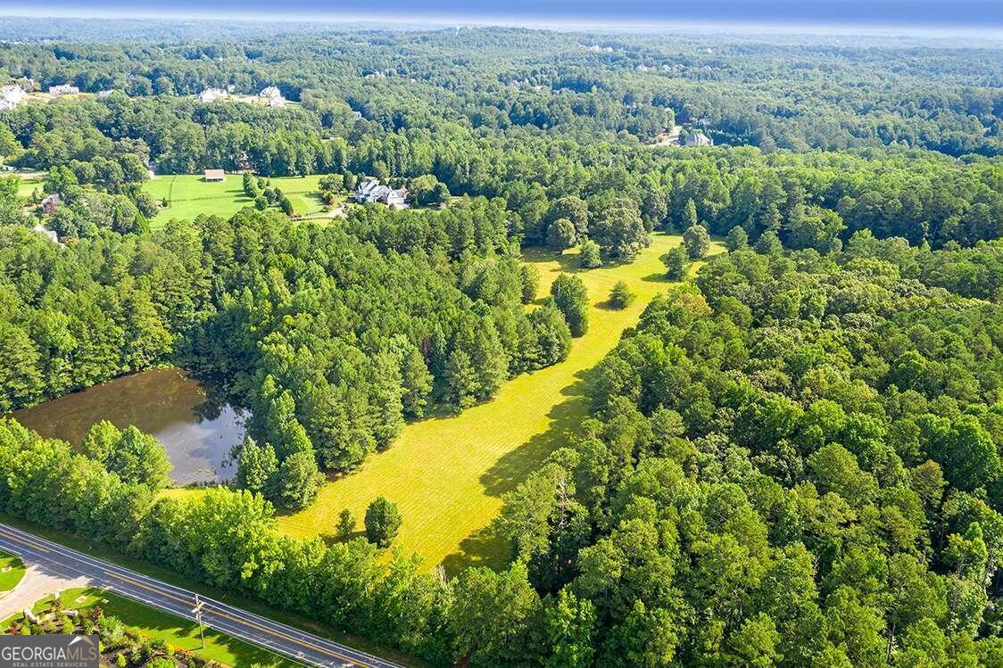 Attention Developers, Investors, and Buyers! Outstanding Opportunity to develop or make this your own paradise! Prestige 50.09 acres (2 adjoin parcels) located in prestigious Milton/Alpharetta, Georgia. This property is located amongst equestrian farms, facilities, and multi million dollar properties. One of the last offerings of this size in this area- and one of the best you can imagine. Property offers a 1.8 acre pond which is fed by a drilled well. The access to the cleared area is from Freemanville Road. Make it your epic estate site or developers may choose to build million dollar + homes on gentle rolling homesites. Property would be highly suitable for an equestrian facility. Bring your dream and make it a reality. Just a very short distance to downtown Alpharetta where you will find upscale shopping, fine dining, casual restaurants, and numerous activities. Easy access to GA-400 without a hassle or sound of traffic. Don't miss making your appointment to see this fabulous property before it is not available. No surprises here! This is beautiful property.