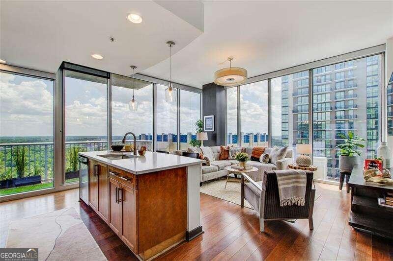 Experience luxurious living from the second you walk in the door! This Southeast corner unit rarely comes available in one of Midtown's best high-rises! Washed in natural light, this unit has two full walls of floor-to-ceiling windows, automated solar shades, hardwood floors, and an open floorplan. The welcoming entry foyer leads to a newly renovated gourmet kitchen with island, quartz countertops, stainless steel appliances, designer backsplash and custom cabinets overlooking the large living room, creating the perfect space for entertaining. Venture out onto the balcony and see the gorgeous skyline with views of the Midtown tree canopy, Stone Mountain and Ponce City Market. Two spacious bedrooms, each with their own full bath, also have spectacular views and thoughtful roommate friendly floorplan ideal for space and privacy. Excellent storage with the Owner's suite walk in closet, 2nd bedroom closet, hall closet, and laundry closet. Indulge in the unmatched amenities this development has to offer including 24/7 concierge, beautiful gardens, large fitness center, junior Olympic pool with city views, grilling courtyard, business center, and a club room for social gatherings and entertainment. It also has two deeded and secured covered parking spaces. Walkable to some of the city's best restaurants, the Fox Theater, Whole Foods, Piedmont Park, Emory University Hospital and Georgia Tech. 2513 has had only one owner and has been meticulously maintained. Step outside your door to all the city has to offer and the epitome of in-town living!