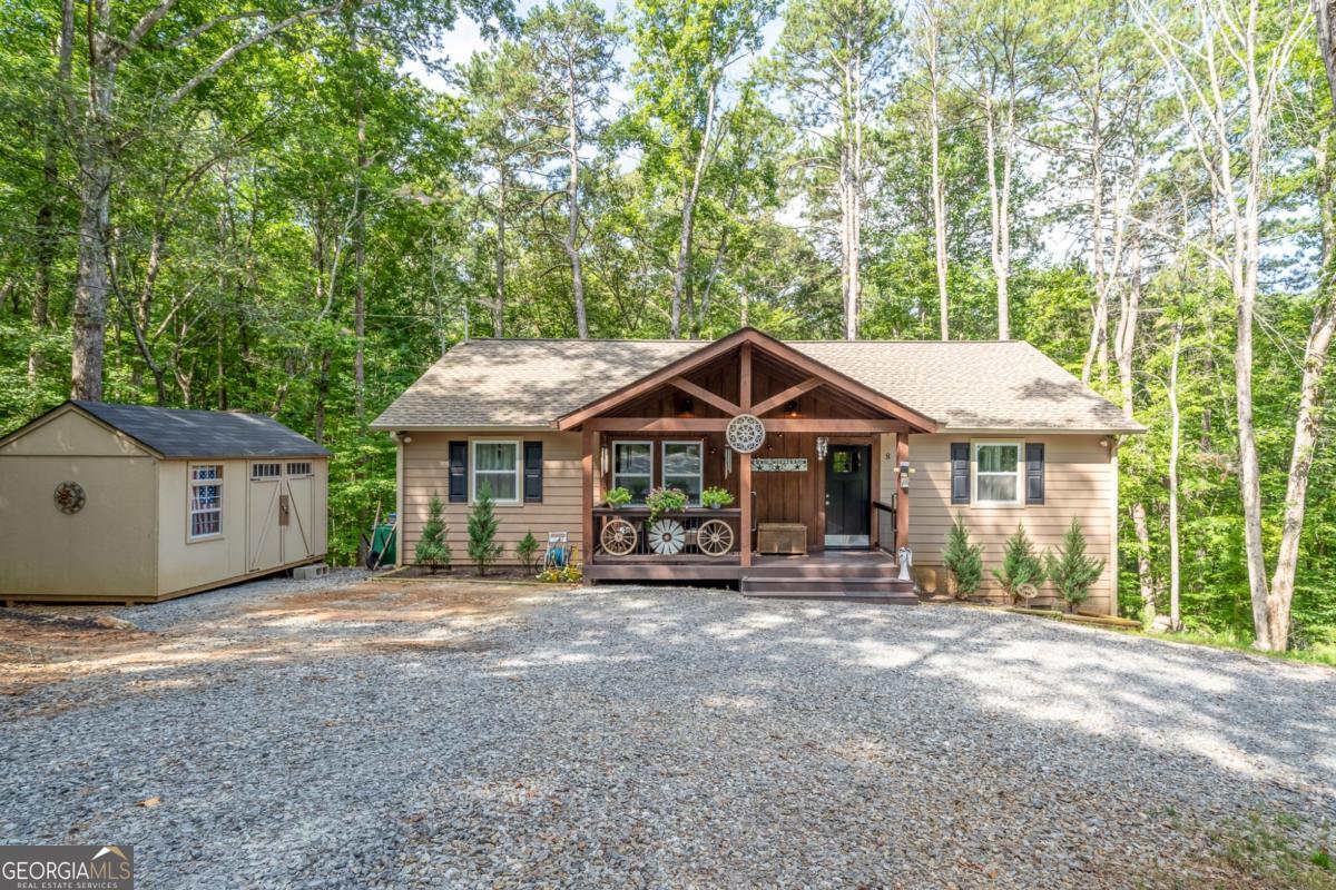 Step into comfort and style with this beautifully maintained 3-bedroom, 2-bathroom ranch home, only 3 years young! Located just minutes from the river and ready to welcome you home!! This home offers a peaceful retreat with thoughtful upgrades throughout. The open-concept living area offers cozy gas log fireplace, perfect for relaxing or entertaining. The kitchen is a chef's dream-featuring custom soft-close cabinets, granite countertops, a central island, and stainless steel appliances. A large laundry/pantry room adds functionality, while cute accent barn doors give the home added charm and character. The primary suite comfortably fits a king-size bed and boasts a luxurious bathroom oasis complete with a grand tile shower with rain head, Bluetooth speakers, double vanities, and a massive walk-in closet perfect for any wardrobe or shoe collection. Two additional spacious bedrooms on opposite side of home share a beautifully tiled bathroom with a tub/shower combo. Enjoy morning coffee on the covered front porch with slight river sounds in the background, or host gatherings on the open back deck overlooking nature. A horseshoe driveway makes for easy access and extra parking, and the shed is perfect for extra storage or a workshop. Additional storage in the standing crawl space area. Amenities such as river access, pickleball, gated entrance, 3 pools (one indoor), tennis/basketball courts, mini golf, parks, pavilions, and walking trails. In the heart of wineries, eateries, antique stores, hiking and biking.
