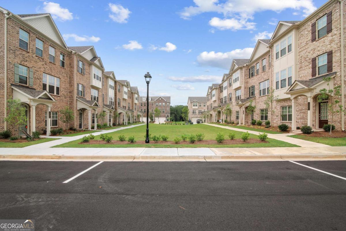 ***SPECIAL: ONE MONTH RENT CONCESSION*** Welcome to Greystone Townhomes where living space is abundant! Need a home office? This home has the perfect space!! Experience upscale living in our beautifully designed 3 bedroom townhome, with a spacious 2-car garage. At Greystone, we believe that luxury should be a part of everyday life. Our homes are thoughtfully crafted with premium features like: elegant quartz countertops and rich hardwood floors, stunning 9-foot tray ceilings create a sense of openness and sophistication. Upgrade your living experience with motion-sensor kitchen faucets and blue UV light bathroom lights. Beyond the beautiful interiors, you'll have access to a host of amenities designed for comfort and leisure. Relax by the community pool, challenge friends to a game of cornhole, or unwind in the peaceful courtyard. Our prime location on Peachtree Industrial Boulevard places you just minutes away from all the best that Gwinnett County has to offer, whether it's shopping, dining, or entertainment. At Greystone Townhomes, we make leasing a seamless experience. Our small, professional management team is dedicated to handling everything from lawn care to maintenance requests, so you can focus on what matters most. Plus, we're a pet-friendly community, so your furry friends are welcome too! Come discover the luxury of leasing at Greystone Townhomes and make us your new home. We're ready to welcome you as our newest resident! *Pictures are of model unit.