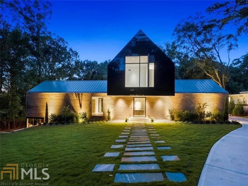 This New Construction smart home modern residence is designed to maximize the incredible views of the property and is perfectly sited around a 65 foot pool on a private, flat 1.1 acre lot in Buckhead. Inside as the sun reflects off of the pool, reflections of light move across the ceiling throughout the day through the 3 story glass curtain wall by Reynaers (Belgium) by Expert Window and door. The kitchen,designed by Design Galleria is exceptional with Temmer marble counters and a hidden walk in pantry.Steam Wolf oven and Sub Zero complement the custom cabinetry. The main entrance and lower doors are pivoting by La Cantina. Exterior brick is Meridian brick and the black reflective wall panels, the first in the US are Nichiha Miraia panels by Legendary Exteriors. The plumbing fixtures are by Porcelanosa and Dornbracht. The finish level is excellent and a collaboration with Harrison Design Architects. The main living room space has a full bar,game room with fireplace, 2 bedrooms/bathrooms that open out to the pool. The master bedroom suite is on the main level with study and separate dressing rooms. The upstairs features 2 bedrooms/baths and an additional laundry room. This home is energy efficient and completely wired for whole house automation. Elevator shaft and 3 car garage near the kitchen