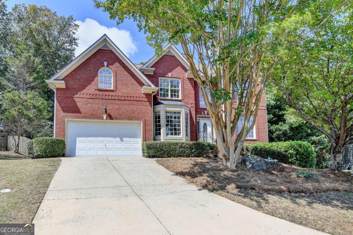 Experience unparalleled living in this stunning brick-front residence, designed for both comfort and style. A grand double foyer and elegant hardwood floors welcome you to an open, flowing floor plan. The versatile main level features a private in-law suite and a dedicated home office, offering flexibility for a modern lifestyle. Upstairs, the expansive primary suite is a serene retreat, complete with a generous bonus room that can serve as a second office, oversized closet, or sitting area. The upper level also provides a beautiful, airy flex space, perfect for a media room, playroom, or art studio. The heart of the home is an open-concept living area where a cozy, stone-clad fireplace anchors the family room, which flows seamlessly into a separate breakfast room and a charming breakfast bar. Step outside to a screened-in patio, where you can enjoy peaceful moments overlooking the serene, fenced-in backyard. A full unfinished basement! This home is conveniently located with easy access to major interstates, premier shopping, and dining.