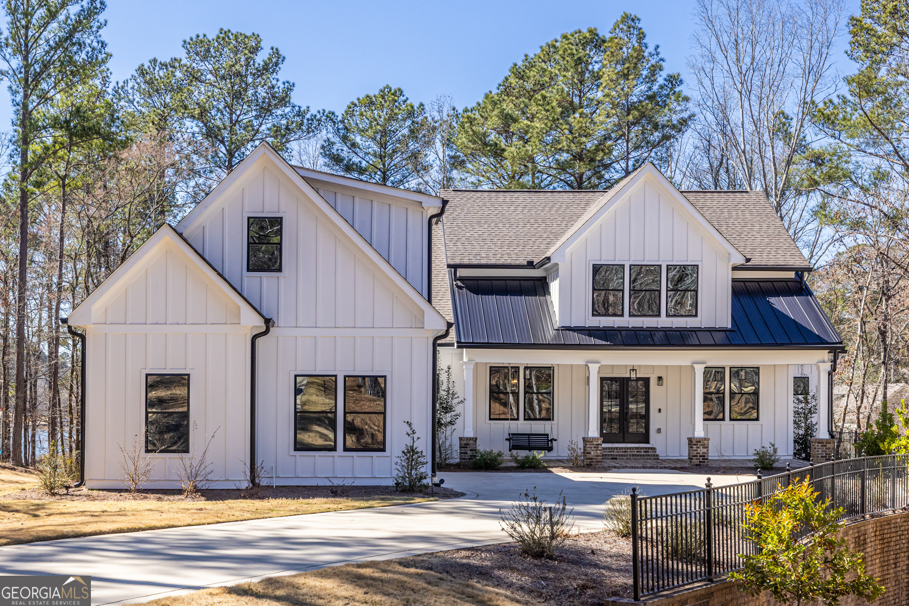 Nestled on a breathtaking 0.76-acre lot in the prestigious Harbor Club community, this exquisite home offers stunning views of both Lake Oconee and the Harbor Club golf course. Step inside from the rocking chair front porch to an open and inviting floor plan that seamlessly blends style and functionality, creating the perfect space for both relaxed living and grand entertaining. The heart of the home is the main floor living area, which includes the oversized vaulted ceiling great room with fireplace, a gourmet kitchen, and a spacious separate dining room. The chef's kitchen was thoughtfully designed with GE Cafe stainless steel appliances, ample cabinetry, and a separate walk-in pantry. Whether hosting a dinner party or enjoying a quiet meal with family, this space is as practical as it is beautiful. Beyond the great room, the vaulted screened back deck offers a picturesque setting for year-round entertaining. Gather with loved ones around the outdoor masonry fireplace, enjoy a meal on the grilling deck, or simply take in the peaceful lake and golf course views that make this home so special. Also on the main level, the expansive primary suite provides a private retreat with a spa-inspired bathroom, featuring a separate tiled shower, soaking tub, and a custom walk-in closet. Two additional bedrooms on the opposite side of the house share a well-appointed Jack & Jill bath and their own walk-in closets, making this level both comfortable and functional for family or guests. Above the attached, over-sized two car garage, a private guest suite has been thoughtfully designed with its own full bath and closet, making it an ideal space for visitors, a second primary suite, a teen retreat, or even a home office. Meanwhile, the fully finished basement adds over 2000 square feet of additional living space, complete with a spacious fifth bedroom, a full bath, and a versatile flex area that can be transformed into a home theater, game room, or fitness studio. With abundant storage, this lower level offers both convenience and possibility. Step outside and discover your own private paradise. A covered lower-level deck expands your outdoor living space, while your small platform dock with a kayak rack offers direct lake access, making it easy to slip into the water for a peaceful morning paddle on Lake Oconee. Located within the sought-after Harbor Club community, residents enjoy an array of upscale amenities, including a championship golf course, swimming pool, pickleball and tennis courts, a clubhouse, a marina and boathouse, and a vibrant social scene. Golf memberships are available for those who want to perfect their game while soaking in the beauty of this exceptional community. Every detail of this gorgeous home has been carefully crafted to offer a lifestyle of comfort, elegance, and effortless luxury. Experience the perfect blend of serenity and sophistication in this one-of-a-kind home on Lake Oconee.