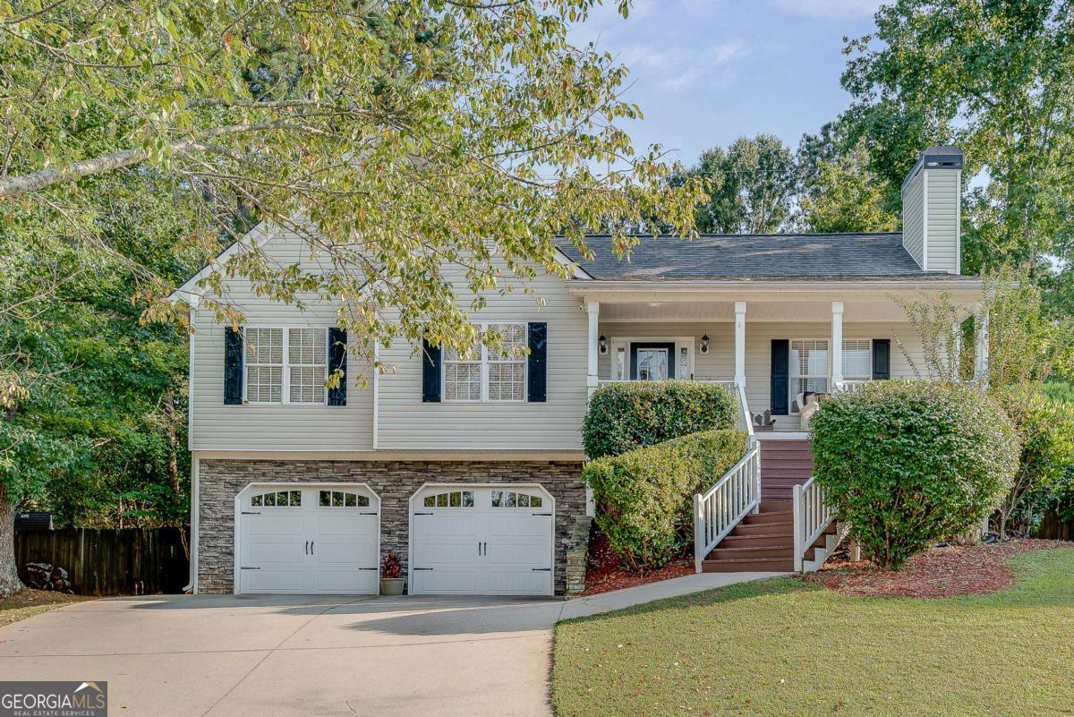 Tucked away on a spacious cul-de-sac lot in Canton's Fox Hollow neighborhood, this charming four-bedroom, three-bath home offers the perfect blend of comfort, functionality, and character. From the inviting rocking chair front porch to the warm, stacked stone fireplace in the sunlit family room, every space feels like home. The kitchen is both stylish and practical, featuring white cabinetry, granite countertops, and stainless steel appliances and breakfast room-ideal for everything from quick breakfasts to weekend entertaining. Step outside to your private backyard oasis, complete with a deck overlooking the sparkling above-ground pool, raised garden beds, fruit trees, and a chicken coop-plus plenty of room left to toss a ball or play with pets. The owner's suite includes tray ceilings, a walk-in closet, and a spacious bath with double vanity, soaking tub, and separate shower. Two secondary bedrooms share a full bath rounding out the main level. Downstairs, the fully finished basement offers a drop zone from the garage, an additional bedroom and full bath, a fireside media room with a beautiful sliding barn door, and a charming reading nook under the stairs. The heated and cooled garage with stamped concrete floors adds the ultimate flex space for a gym, workshop, or hobby room and an abundance of storage. With no HOA, an unbeatable location in the Sequoyah High School district, and easy access to Holly Springs, dining, shopping, and I-575-this is the home you've been waiting for!