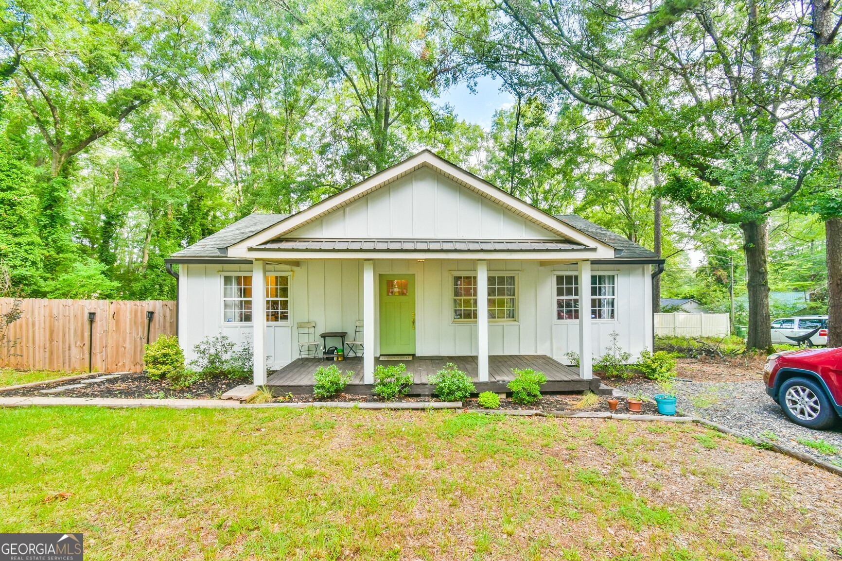 Welcome Home to this adorable renovated cottage just minutes from downtown Monroe! Step into storybook charm with beautifully renovated 3-bedroom, 2-bath cottage nestled on a corner lot in a quiet neighborhood within walking distance of dining & shopping in downtown. Every inch of this home has been thoughtfully updated - from the stylish new kitchen featuring modern soft-close cabinetry, granite countertops & stainless steel appliances, to the fully renovated bathrooms with contemporary fixtures & finishes. New flooring, paint & lighting throughout give the home a bright, welcoming ambiance. The open concept of the living, dining & kitchen area allows for a great flow for entertaining friends around the cozy fireplace. There is a spacious built-in sideboard great for storage and serving. All appliances remain, including refrigerator, washer & dryer. The home features a tankless water heater, newer HVAC, plumbing & electrical. The backyard is privately fenced and has a huge patio with a large serving/prep table that will be great for your cookouts! Enjoy peaceful mornings or quiet evenings on your cozy front porch or great weekend cookouts in the backyard. Whether you are looking for your first home, a quiet retreat, or a low-maintenance lifestyle close to Monroe's shops, dining & events, this move-in ready gem is a must-see!