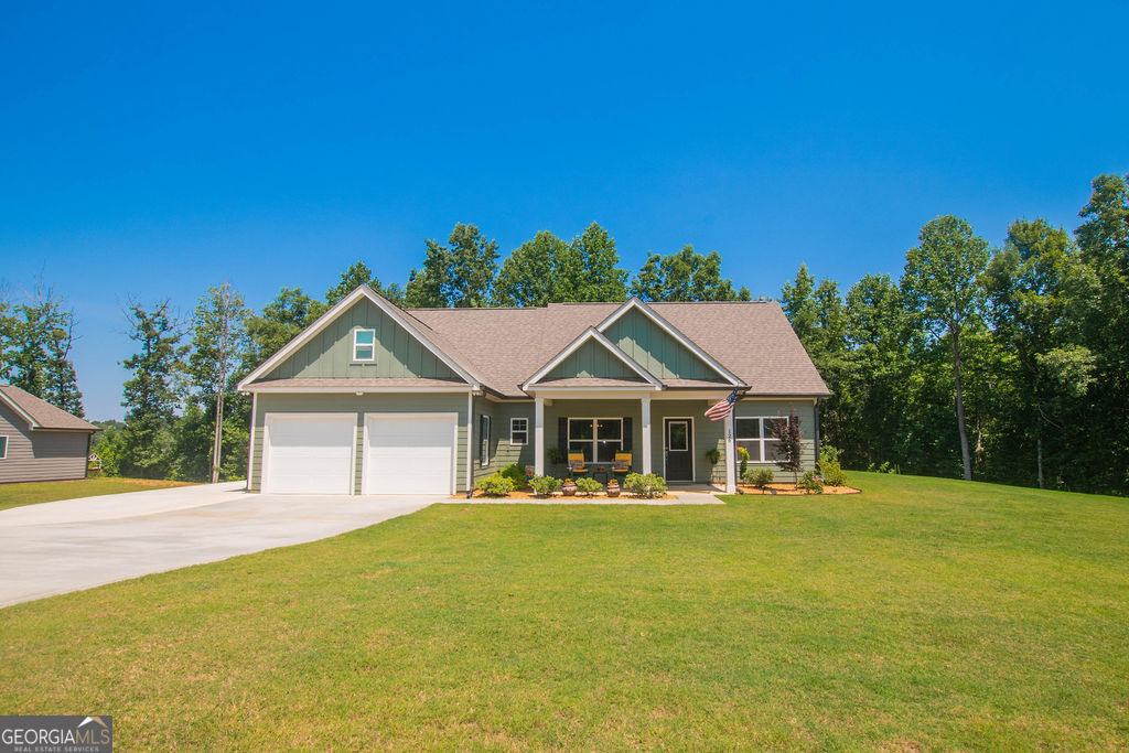 This beautiful 4 bedroom/3 bathroom Craftsman style ranch home sitting on 1.26 acres has been meticulously maintained and it shows! The open floor concept features a split bedroom plan. An inviting foyer leads to the spacious great room that offers vaulted ceilings and a cozy fireplace, and it is open to the kitchen and dining room. The kitchen includes an eat-in breakfast area, kitchen island, granite counters, stainless steel appliances, lots of cabinets, and a walk-in pantry. The master suite includes a spacious bathroom with double vanities, soaking tub, separate shower, and walk-in closet. Two additional bedrooms are also on the main level with a full bathroom, as well as the laundry room. Upstairs you will find a finished bonus room that may be used as a 4th bedroom, a full bathroom, plus there is finished flex space in the attic for an additional storage area. Outside features include an inviting rocking chair front porch, as well as a covered patio that overlooks the private backyard which is perfect for entertaining family and friends. Additional features include added concrete for additional parking, an outbuilding/workshop, fire pit, and backyard fencing. The home is within close proximity to schools, shopping, entertainment and restaurants, including easy assess to I-85, Banks Crossing and Tanger Outlets. Buyers will not be disappointed!