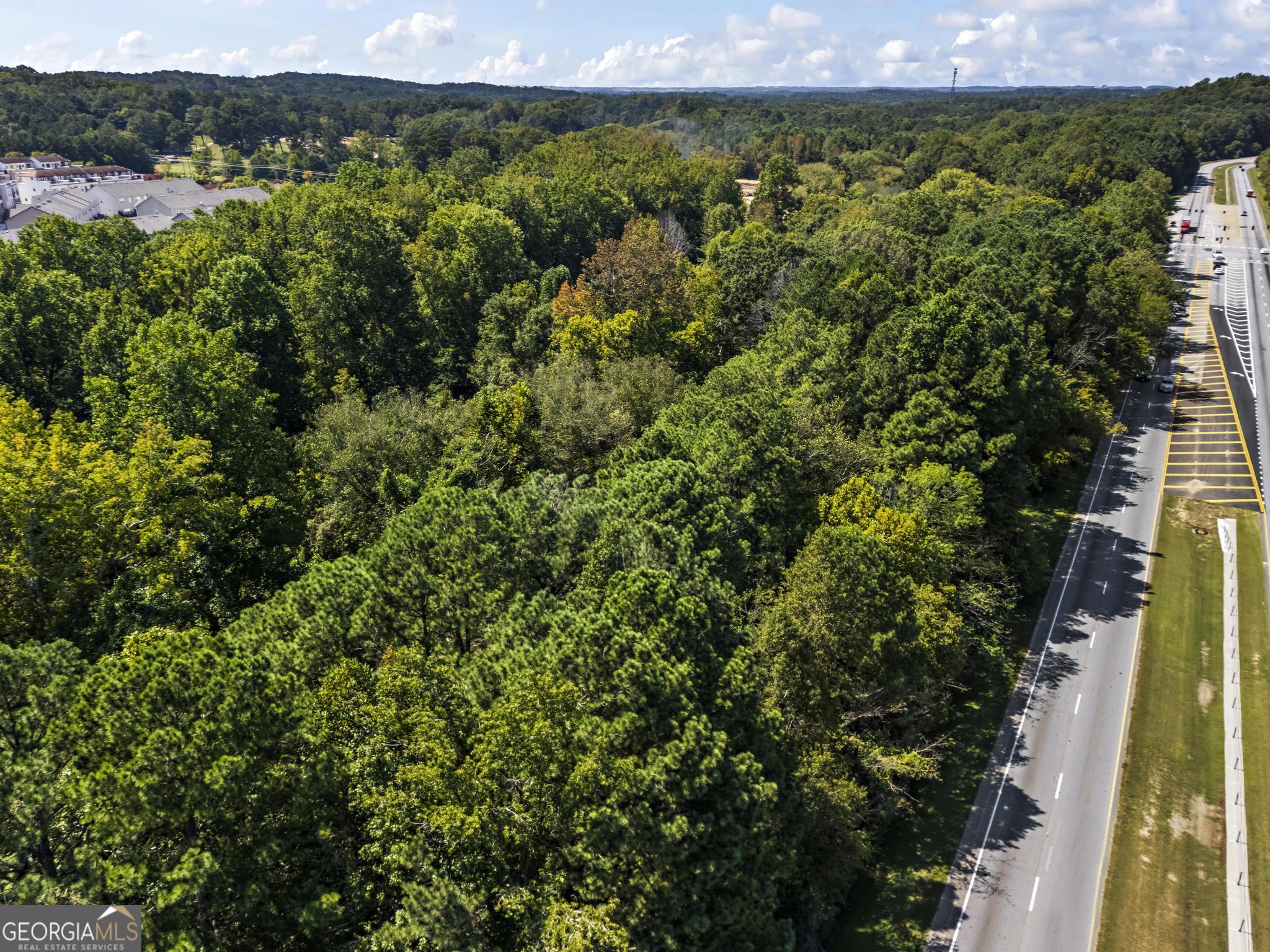 33210 Butner Camp Creek Pkwy, Atlanta, GA 30331 Exceptional development opportunity in South Fulton! This expansive 10.96-acre tract sits prominently at the corner of Butner Road and Camp Creek Parkway, boasting 1,700+ feet of road frontage. Currently zoned R-3 / Mixed-Use, the property offers incredible flexibility-ideal for single-family residences, multi-family projects, subdivisions, schools, religious facilities, or other community-focused developments. Strategically positioned in a high-growth area, the site is just 15 minutes west of Downtown Atlanta, with quick access to the I-285 loop, Hartsfield-Jackson Atlanta International Airport, and an abundance of shopping, dining, and schools nearby. All utilities, including sewer, are available, making this property truly shovel-ready for your next project.